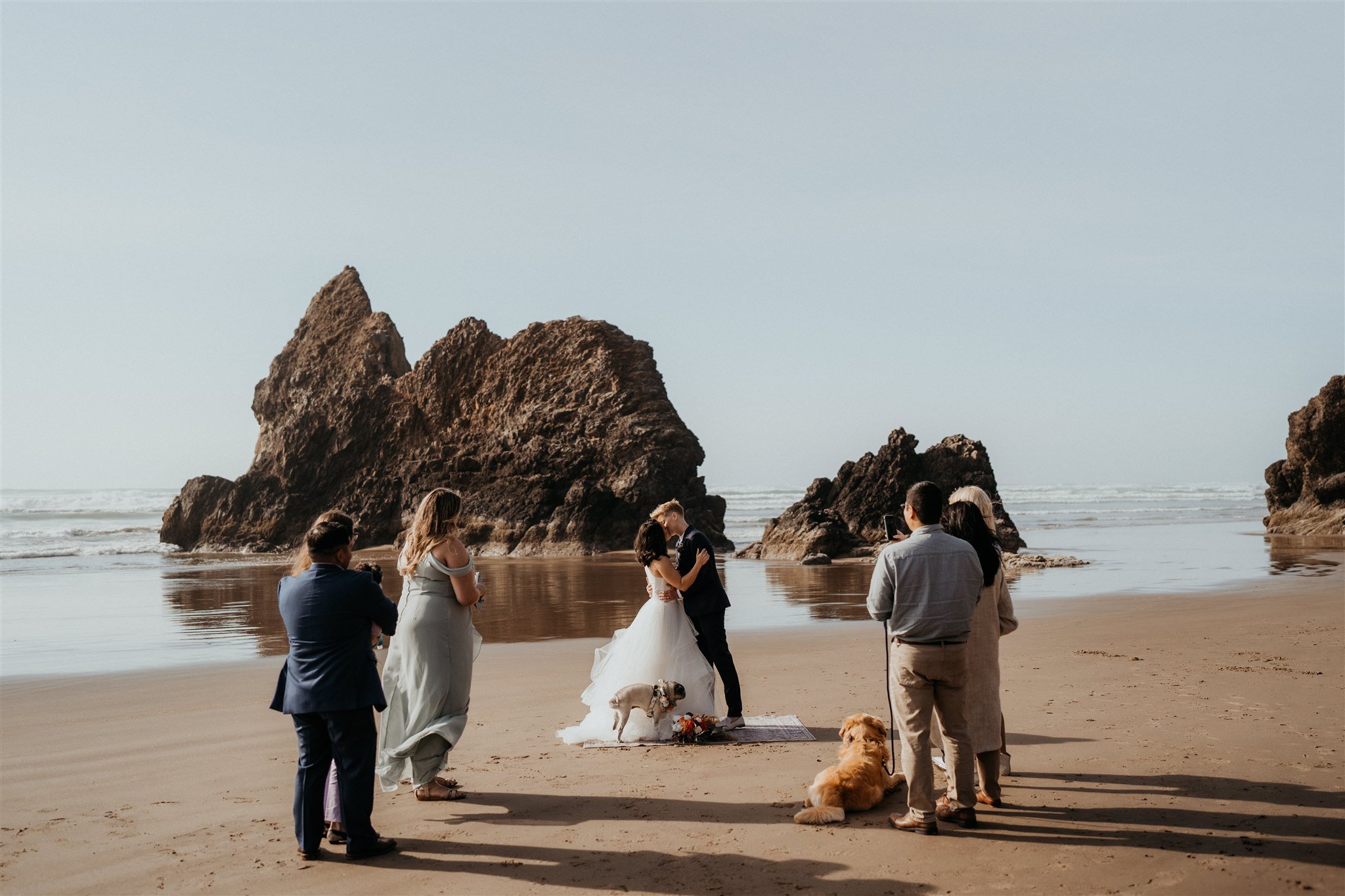 Two brides kiss at Oregon Coast elopement ceremony