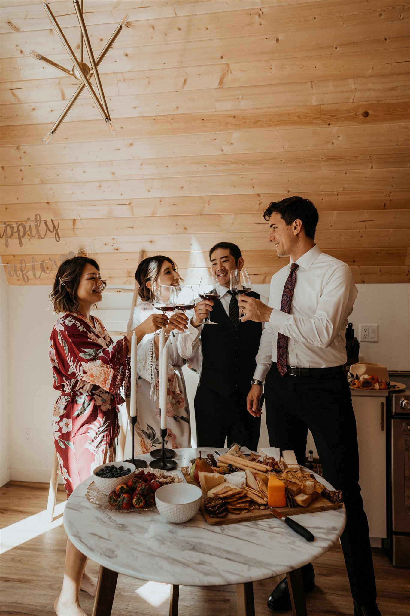 Bride and groom celebrating a morning toast with two friends