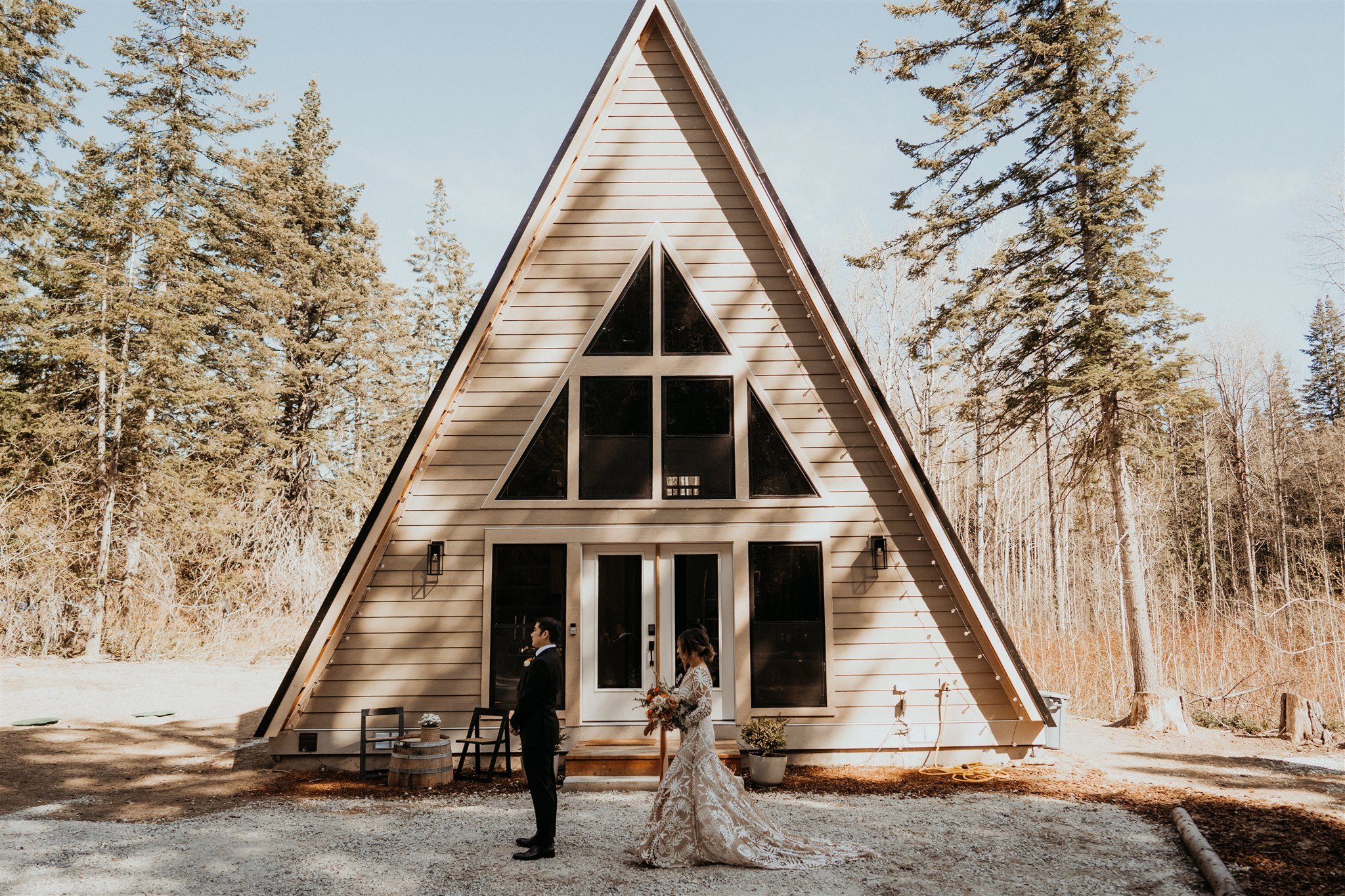 Bride and groom first look in front of A-Frame cabin