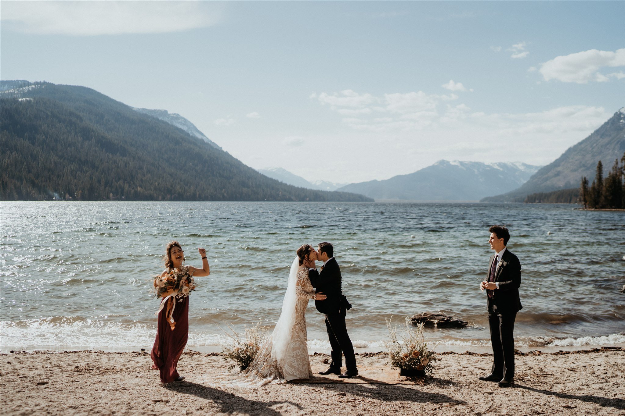 Bride and groom first kiss at Lake Wenatchee in the North Cascades