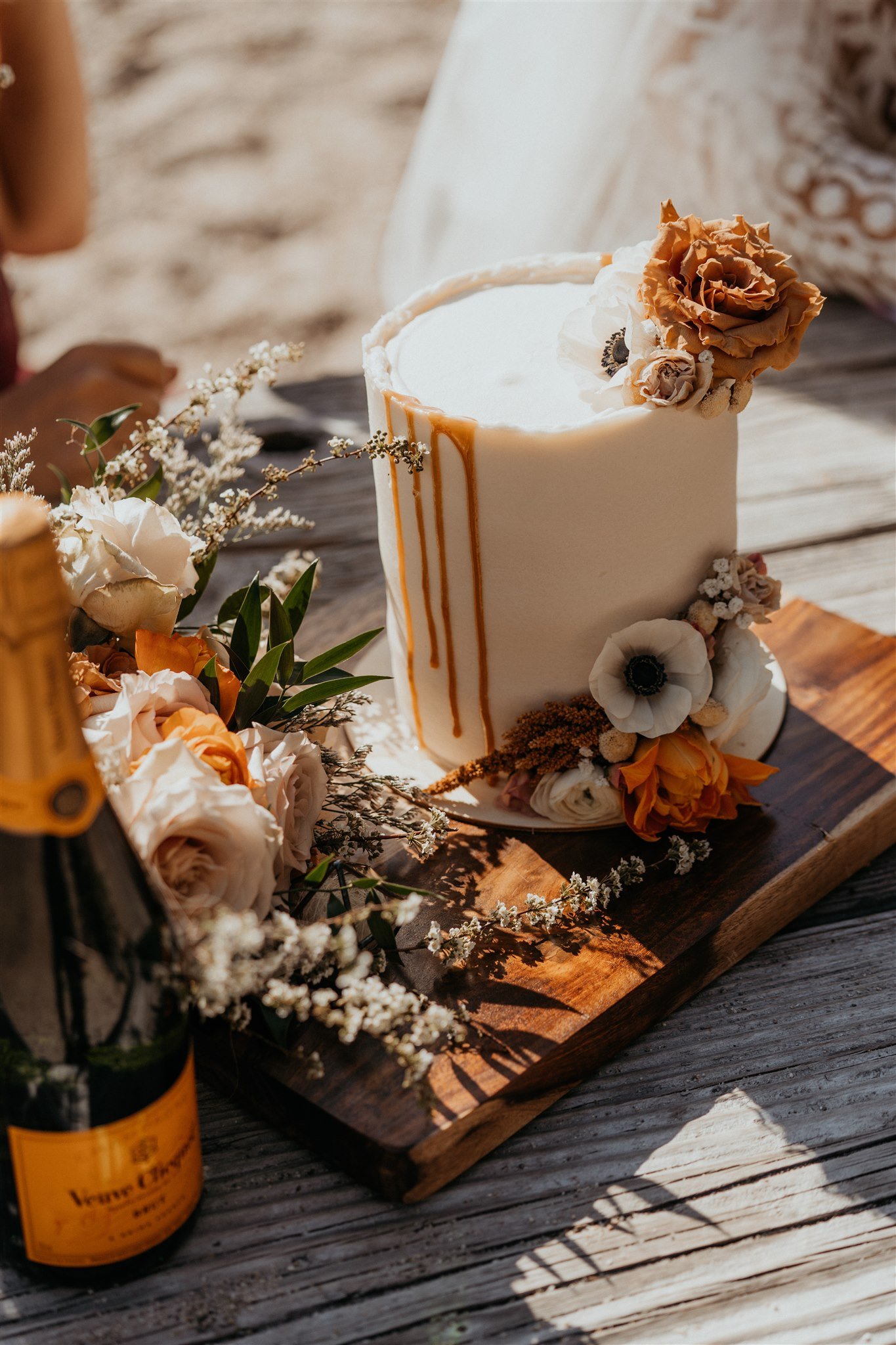 Cream cake and orange wedding flowers