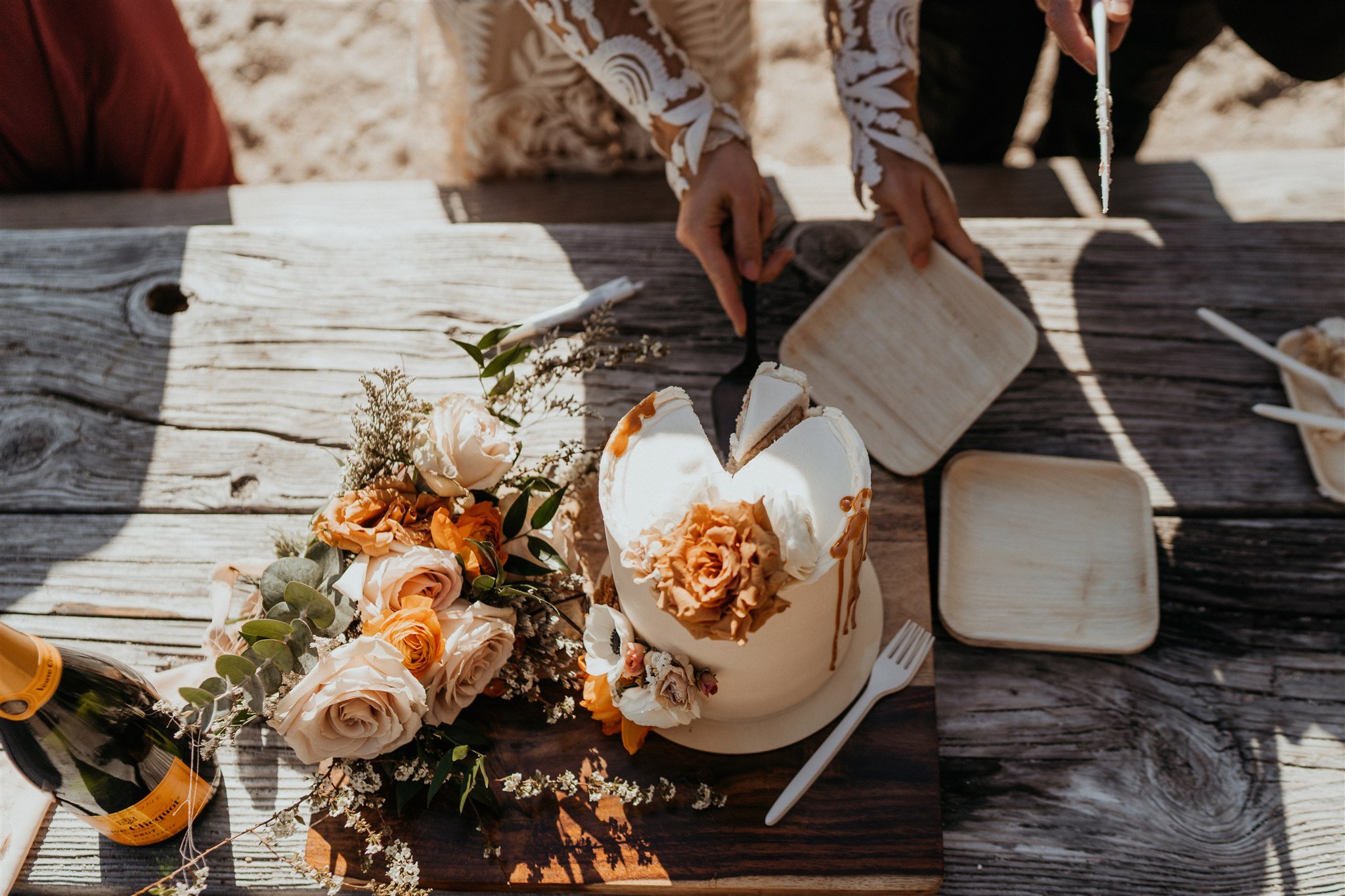 Bride cutting wedding cake at Lake Wenatchee elopement