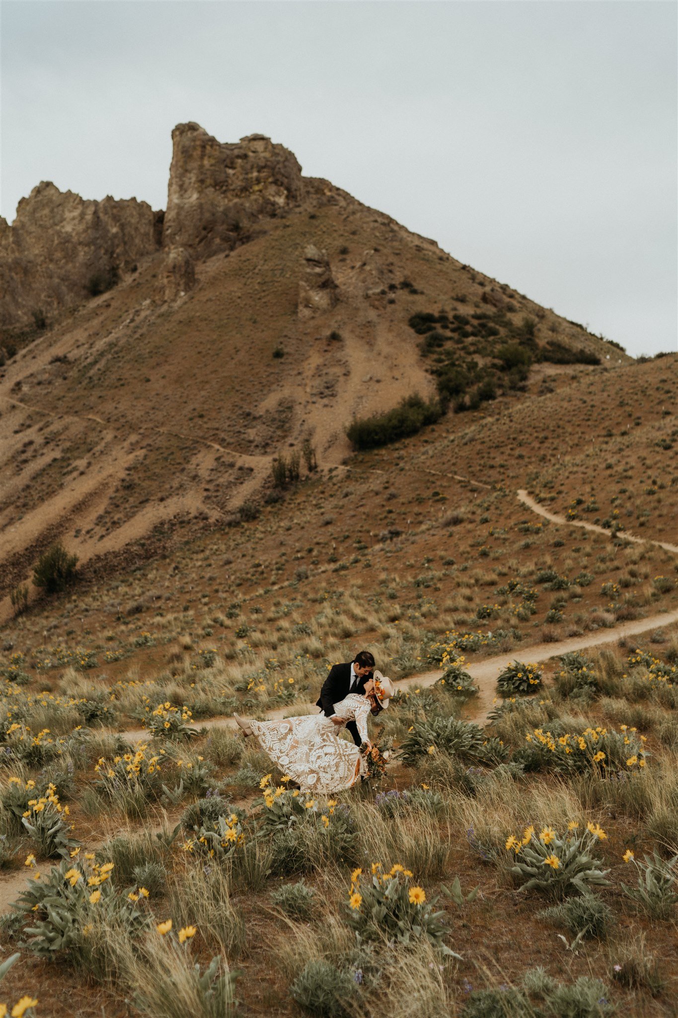 Bride and groom kissing on a trail during their hiking elopement in the North Cascades