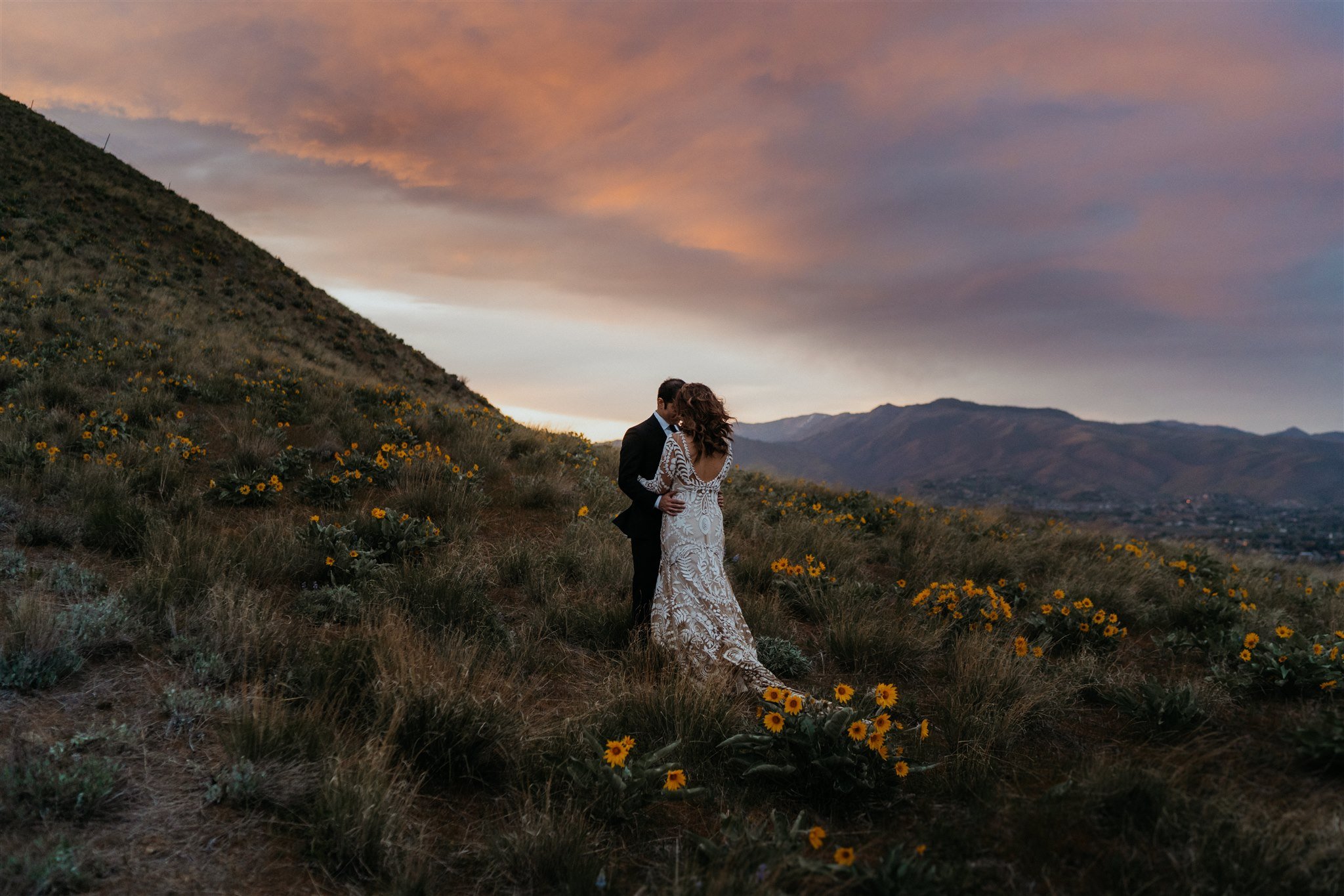 Bride and groom dancing and watching the sunset during their hiking elopement in the North Cascades