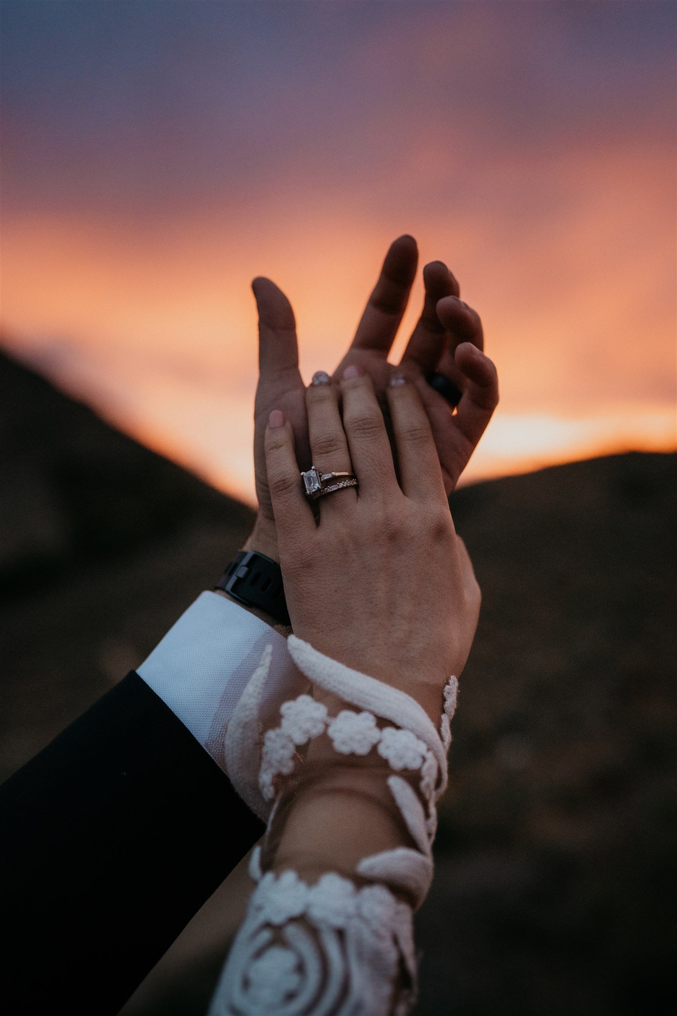 Bride and groom hold hands during sunset in the North Cascades