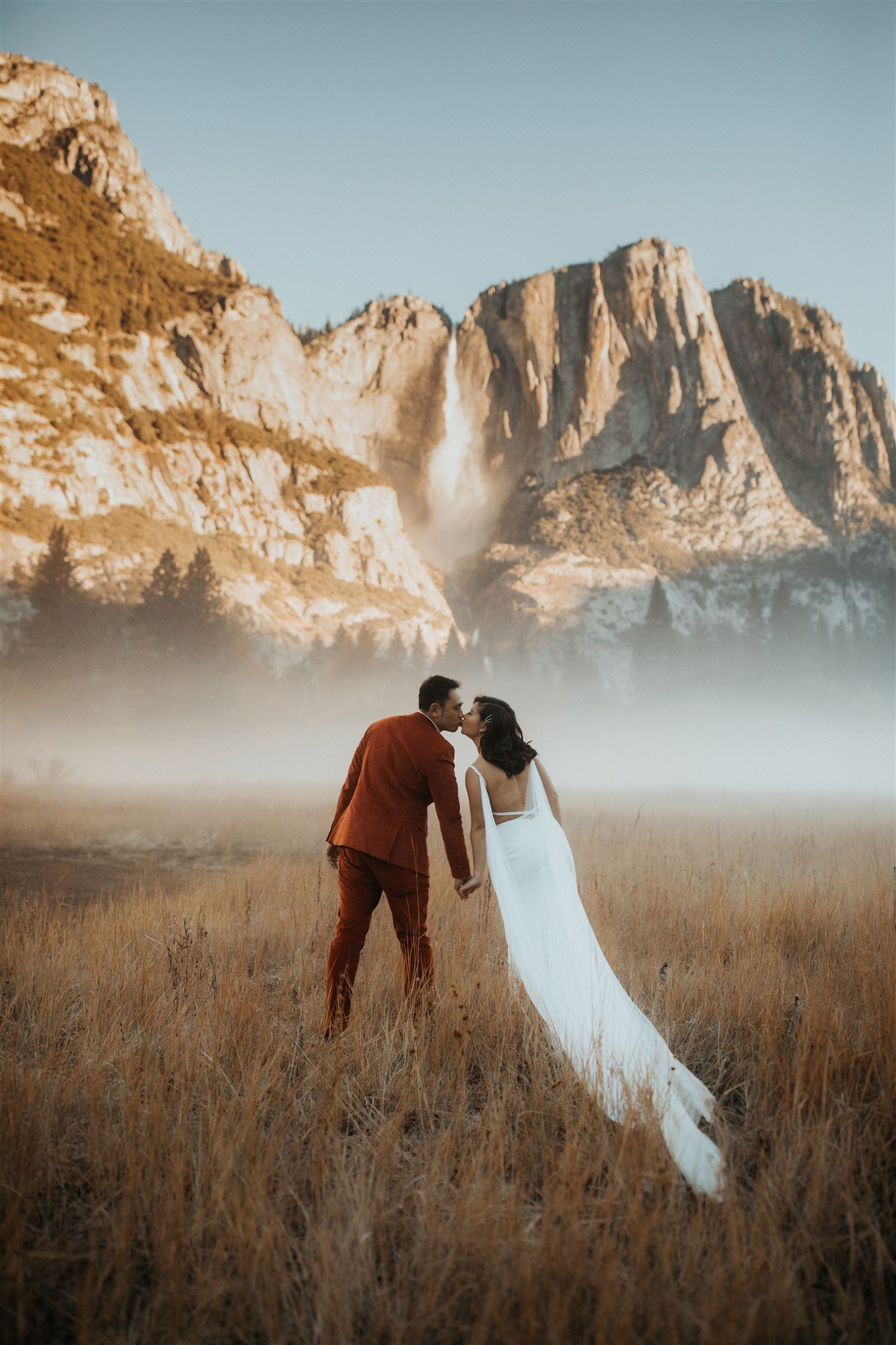Bride and groom kissing in El Capitan Meadow for Yosemite Elopement
