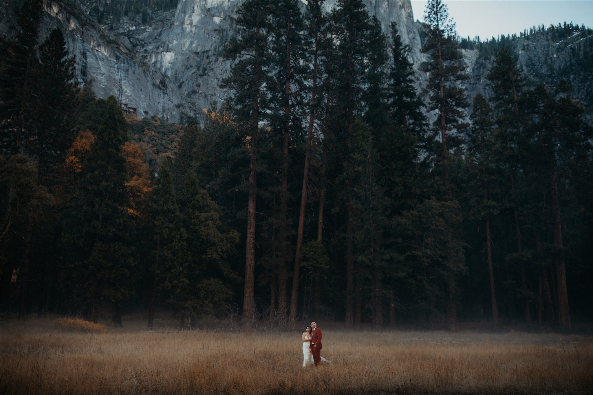 Bride and groom walking through El Capitan Meadow for Yosemite Elopement