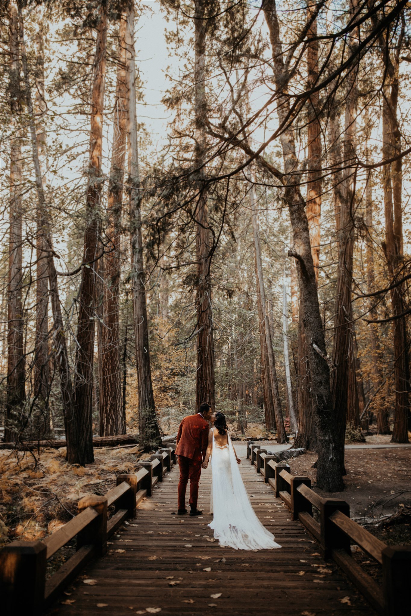 Bride and groom walking through El Capitan Meadow for Yosemite Elopement