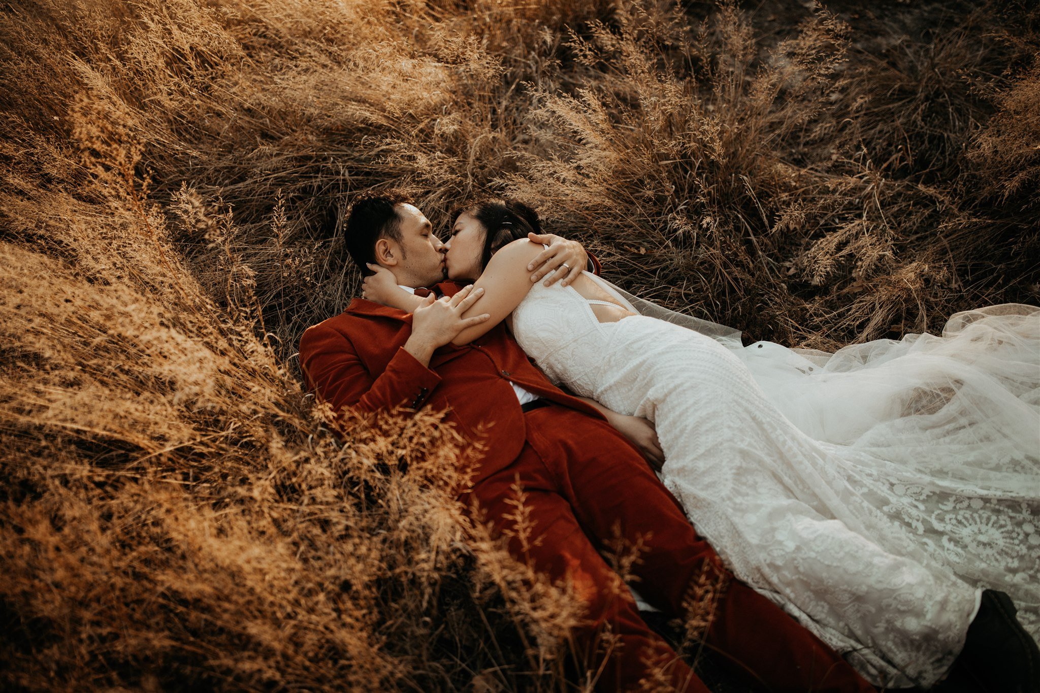Bride and groom laying down in El Capitan Meadow for Yosemite Elopement