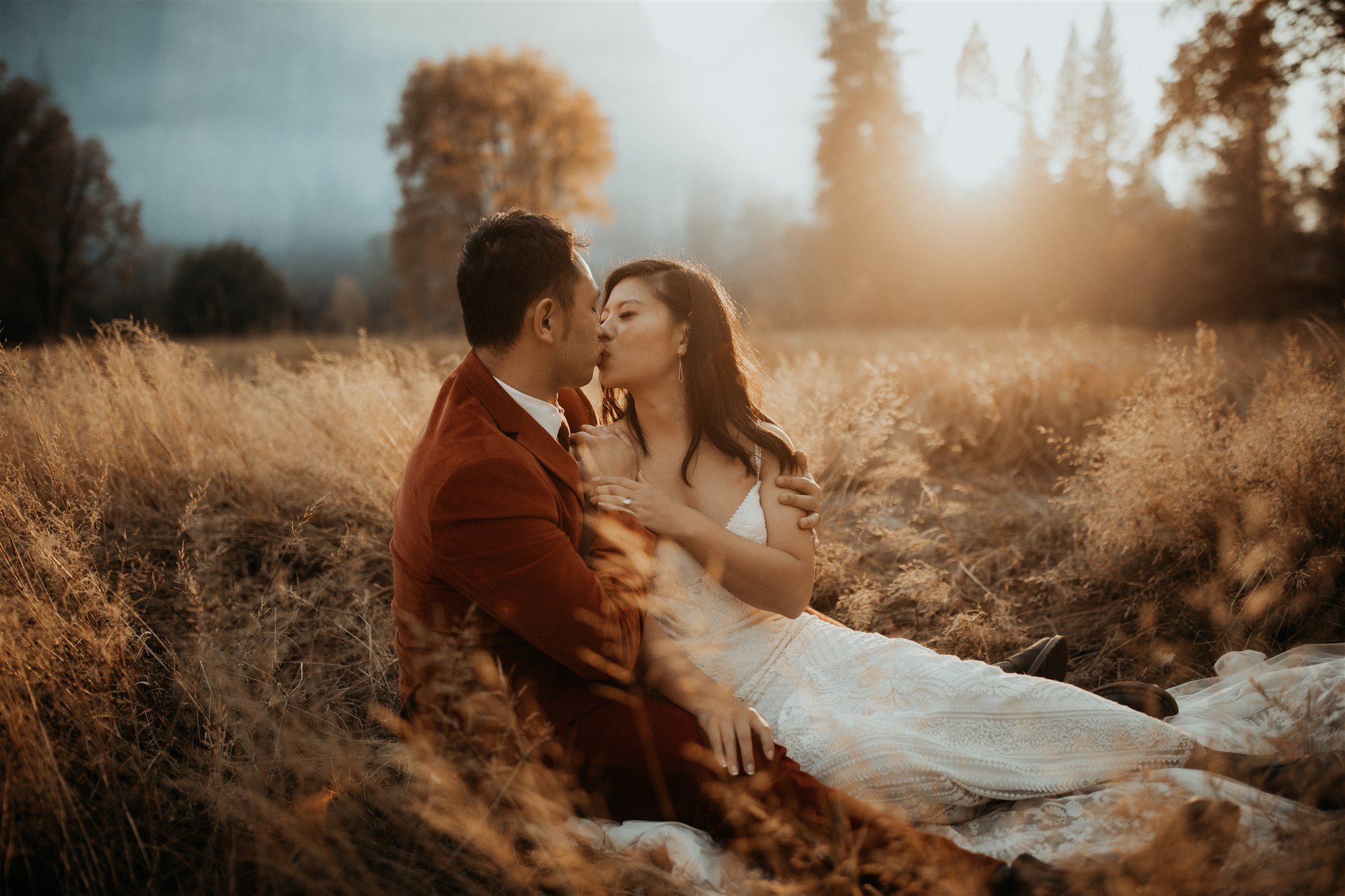 Bride and groom sitting in El Capitan Meadow for Yosemite Elopement
