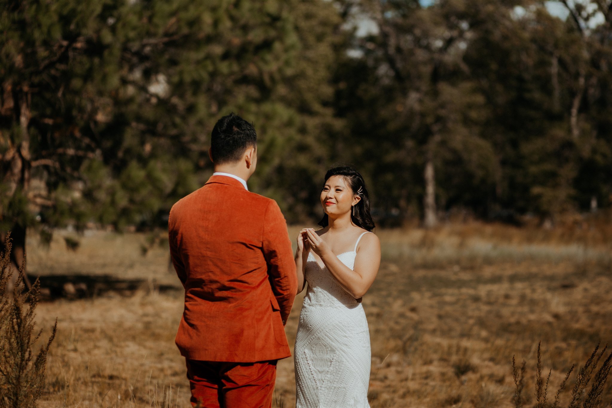 Bride signing vows to groom at El Capitan Meadow