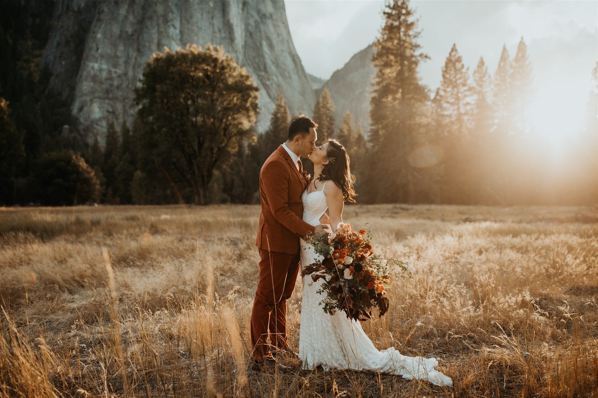 Bride and groom kissing in El Capitan Meadow at Yosemite elopement