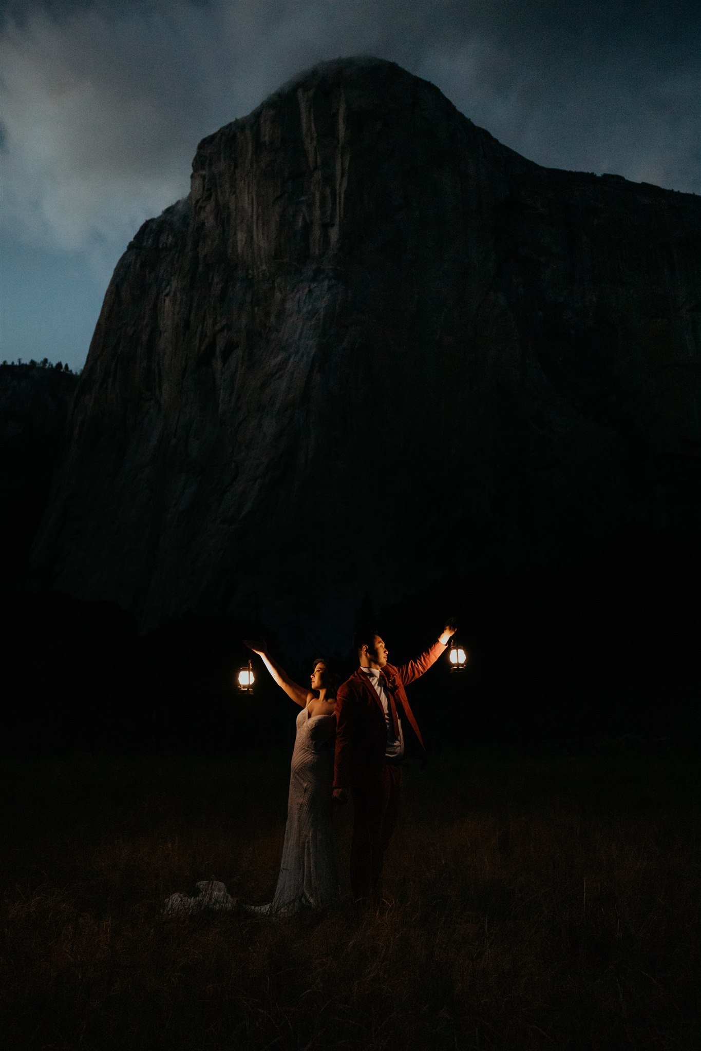 Bride and groom holding lanterns after dark in El Capitan Meadow at Yosemite elopement