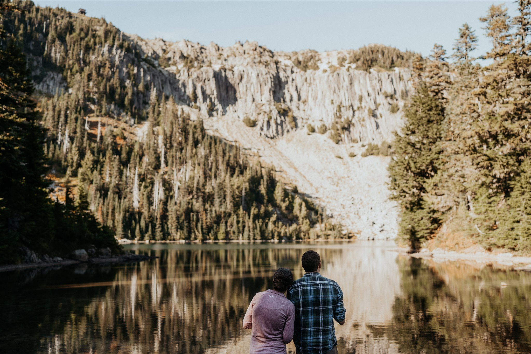 Bride and groom looking out over the lake at Mt Rainier National Park