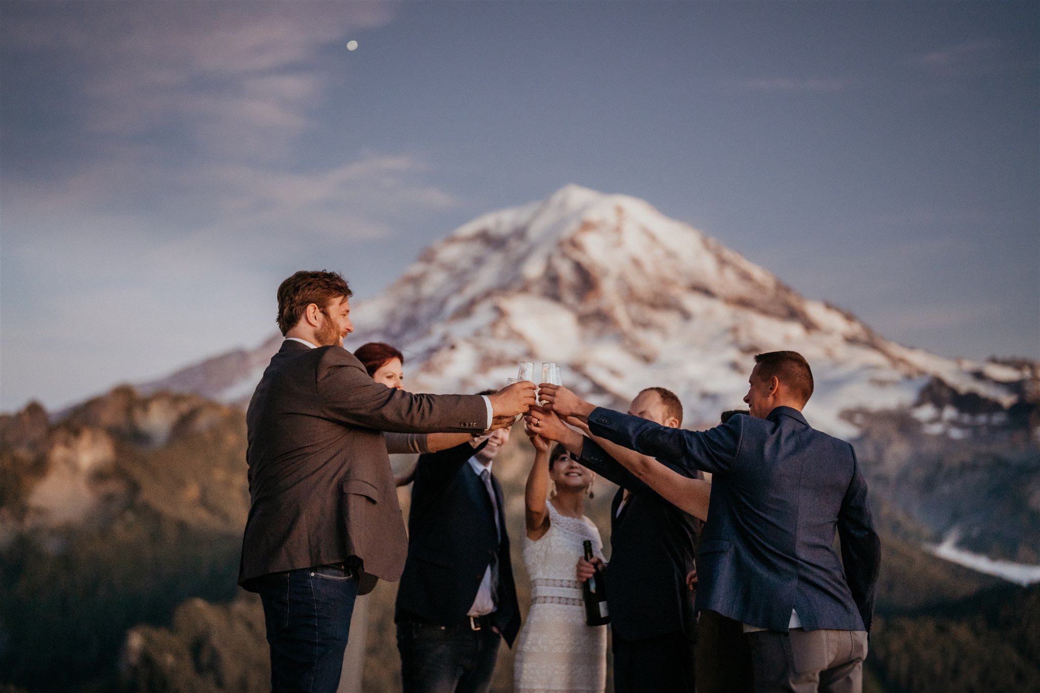 Bride and groom toast with guests at Mt Rainier National Park