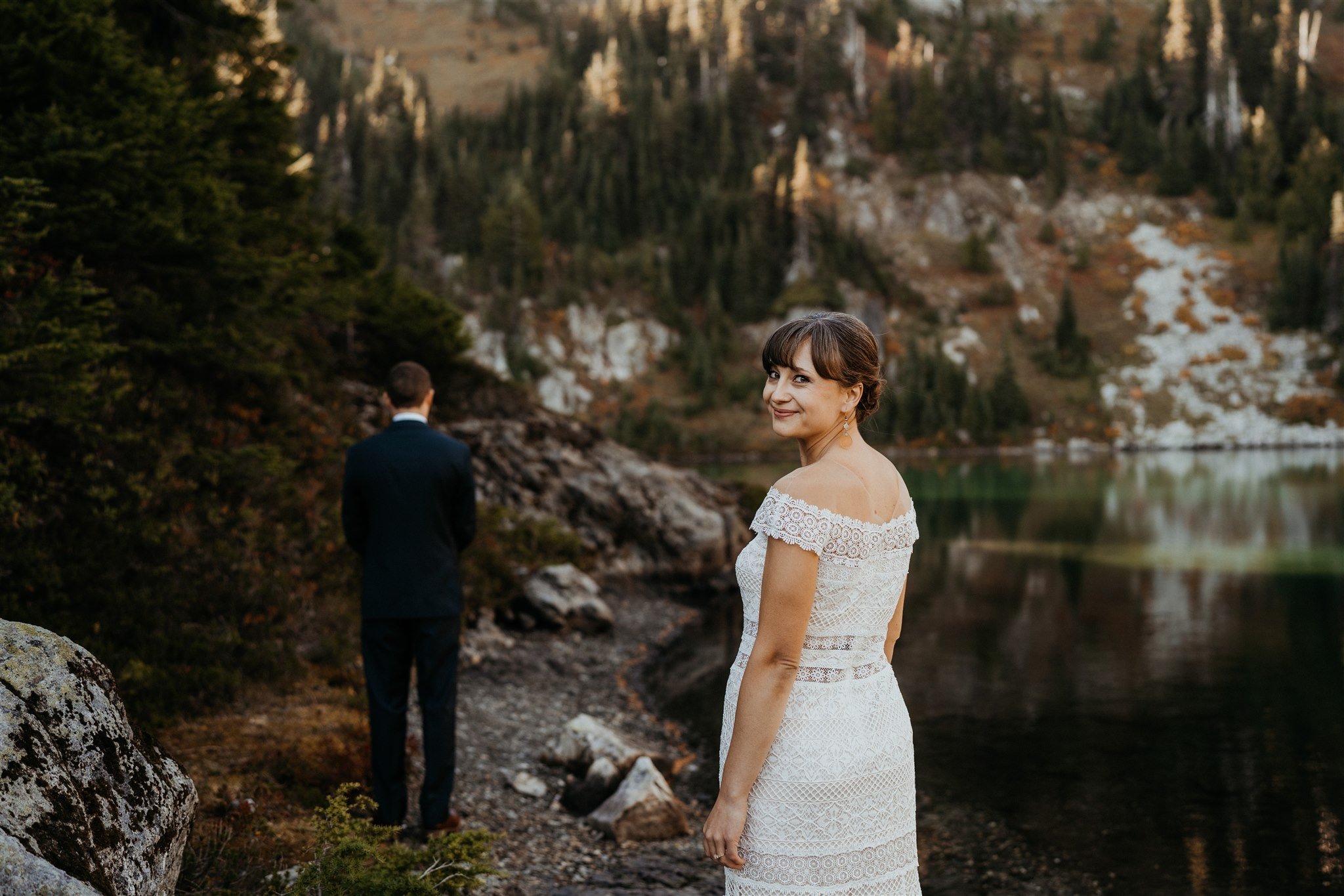 Bride smiling before first look moment with groom in Mt Rainier National Park