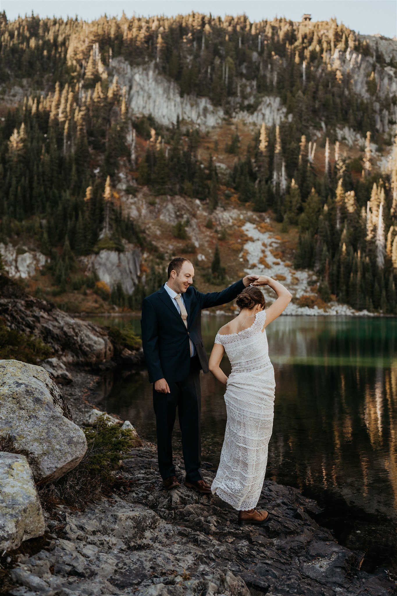 Bride and groom dance near the lake in Mt Rainier National Park