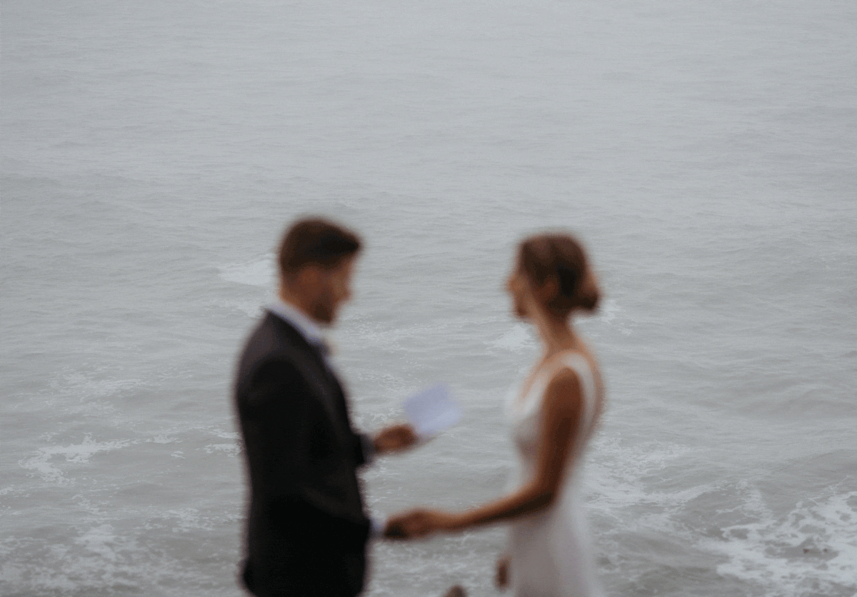 Groom reading vows to bride overlooking the water on the Southern Oregon Coast