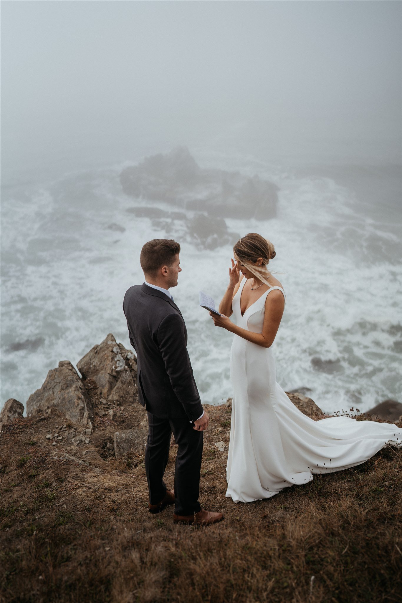 Bride reading vows to groom overlooking the water on the Southern Oregon Coast