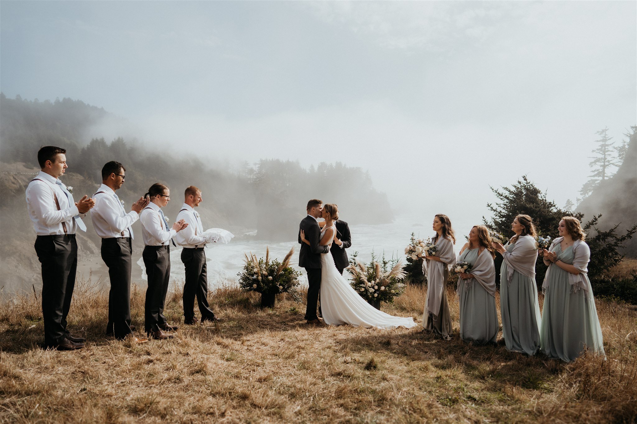 Bride and groom kiss during outdoor wedding ceremony on the Southern Oregon Coast
