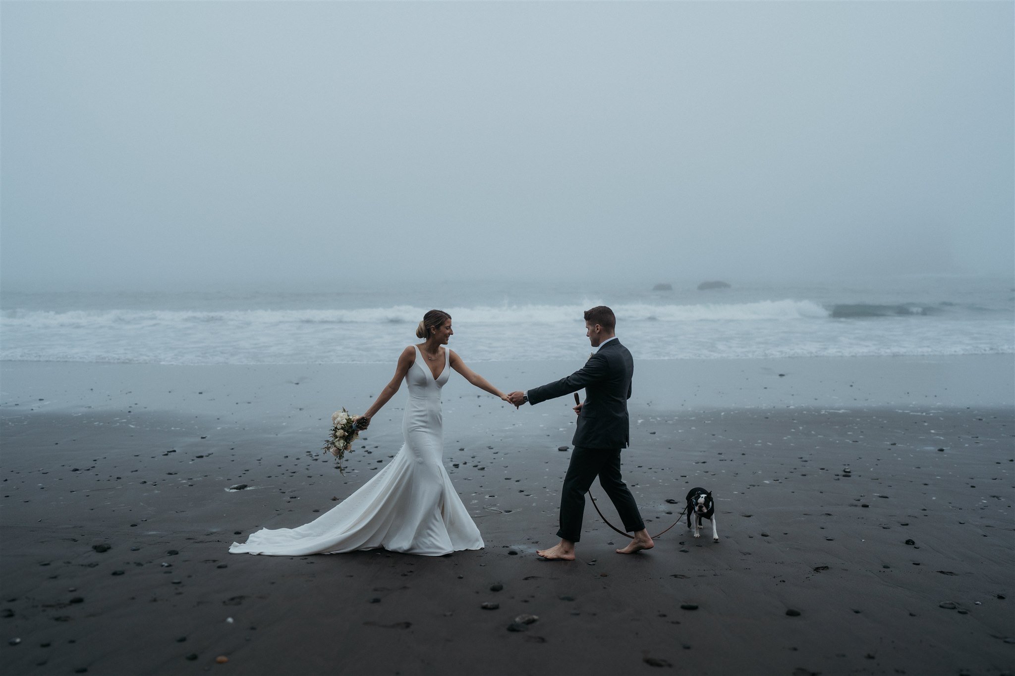 Bride and groom holding hands twirling on the beach on the Southern Oregon Coast