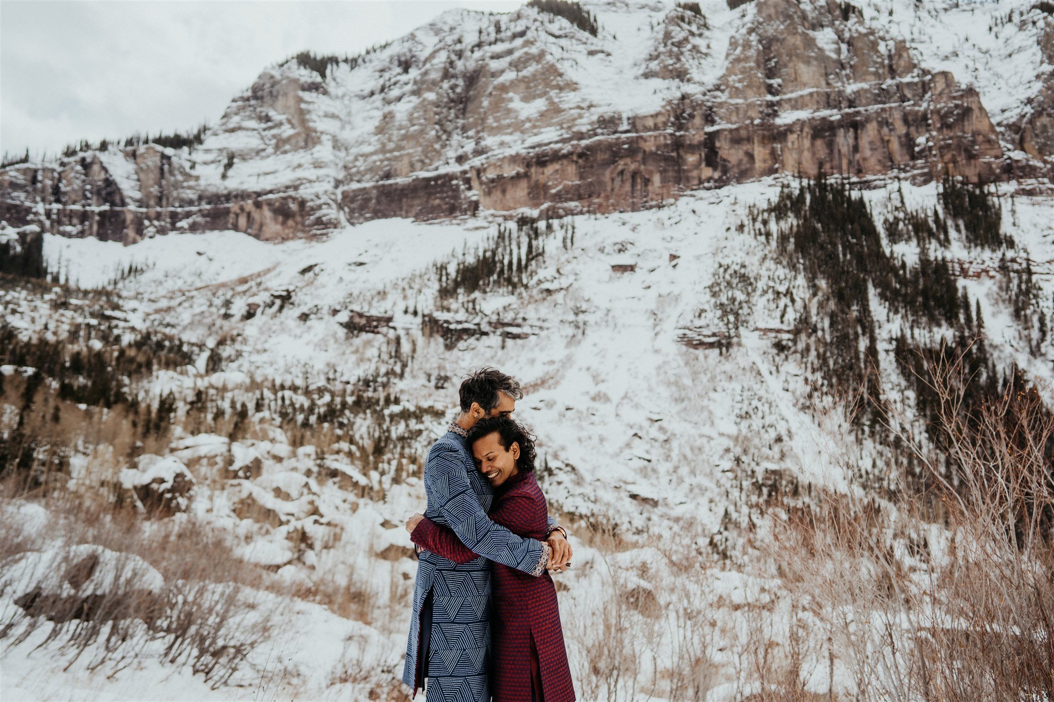 Two grooms hugging at their Colorado mountain elopement
