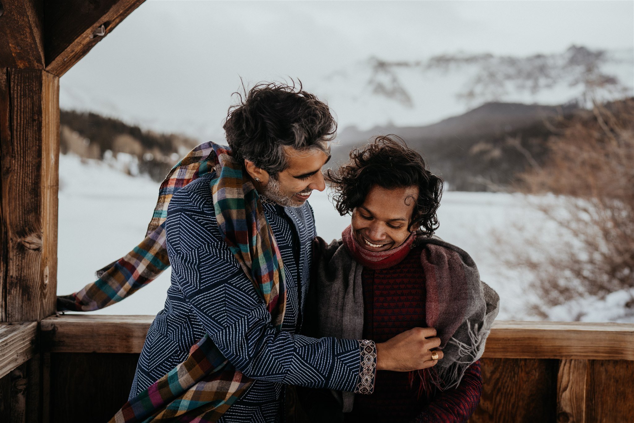 Two grooms hugging during their winter elopement in the Colorado mountains