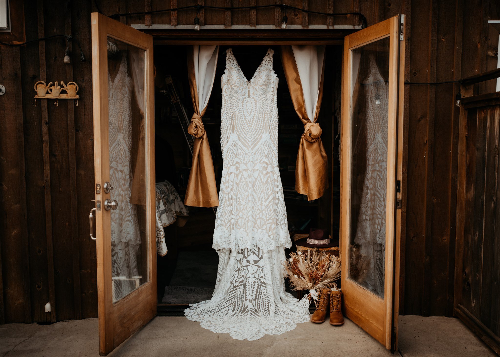 White wedding dress hanging on French doors