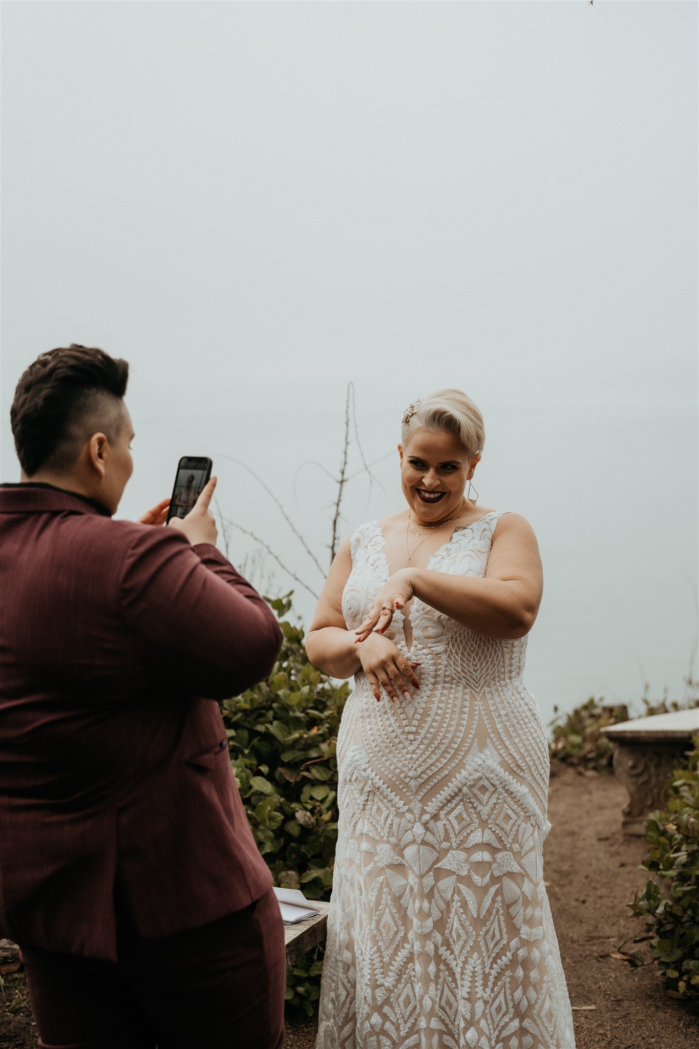 Bride taking a photo of her bride after the elopement ceremony at La Push