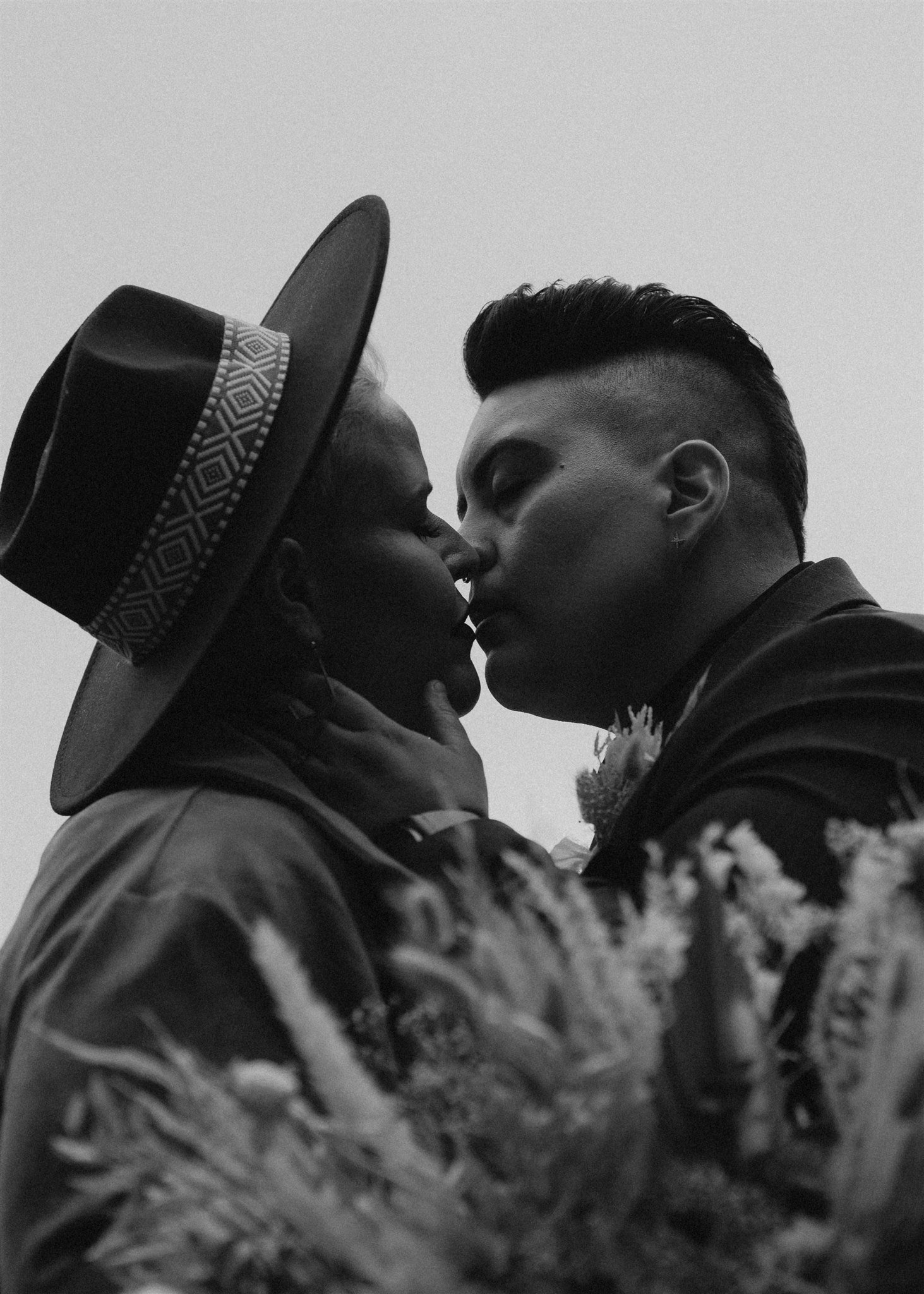 Two brides kissing during fall elopement at La Push