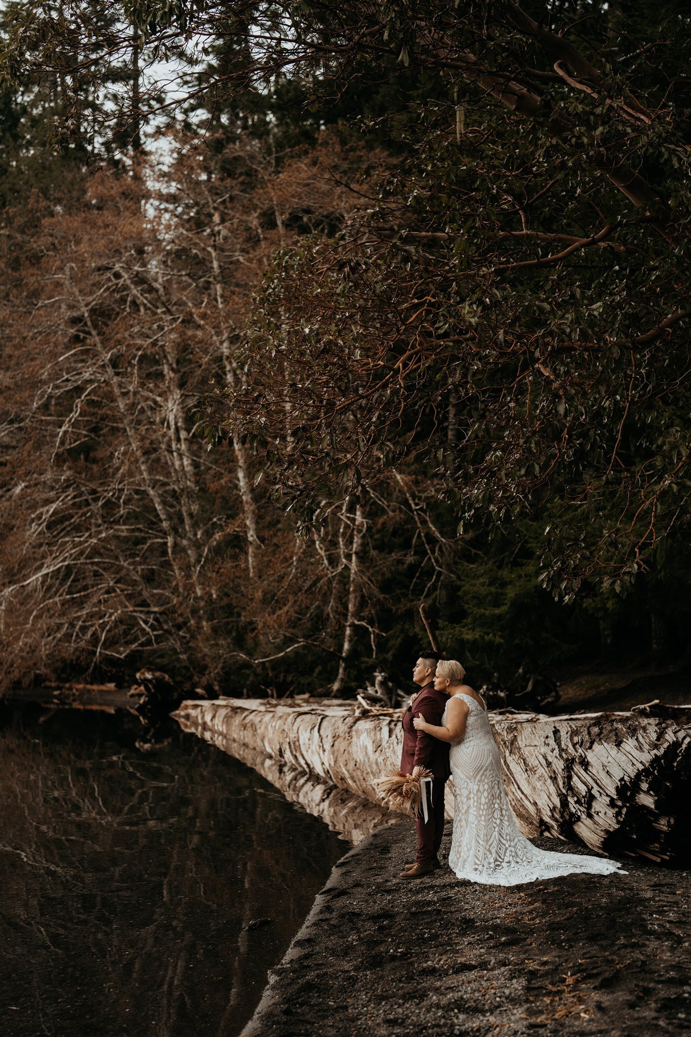 Two brides standing on the beach for their Olympic National Park elopement