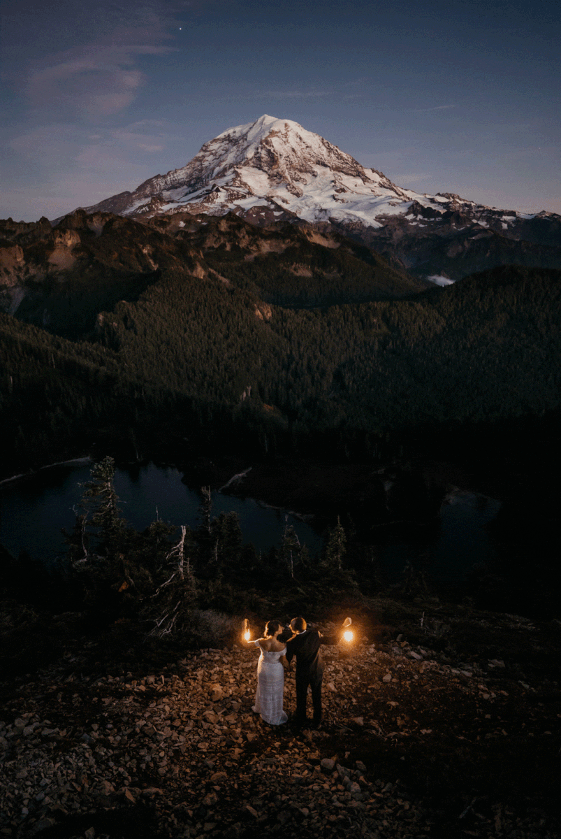 Bride and groom holding lanterns during fall wedding photos at Mount Rainier National Park