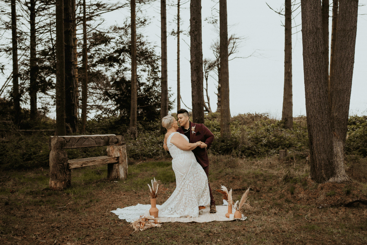 Bride dipping partner backward for first kiss at PNW elopement ceremony