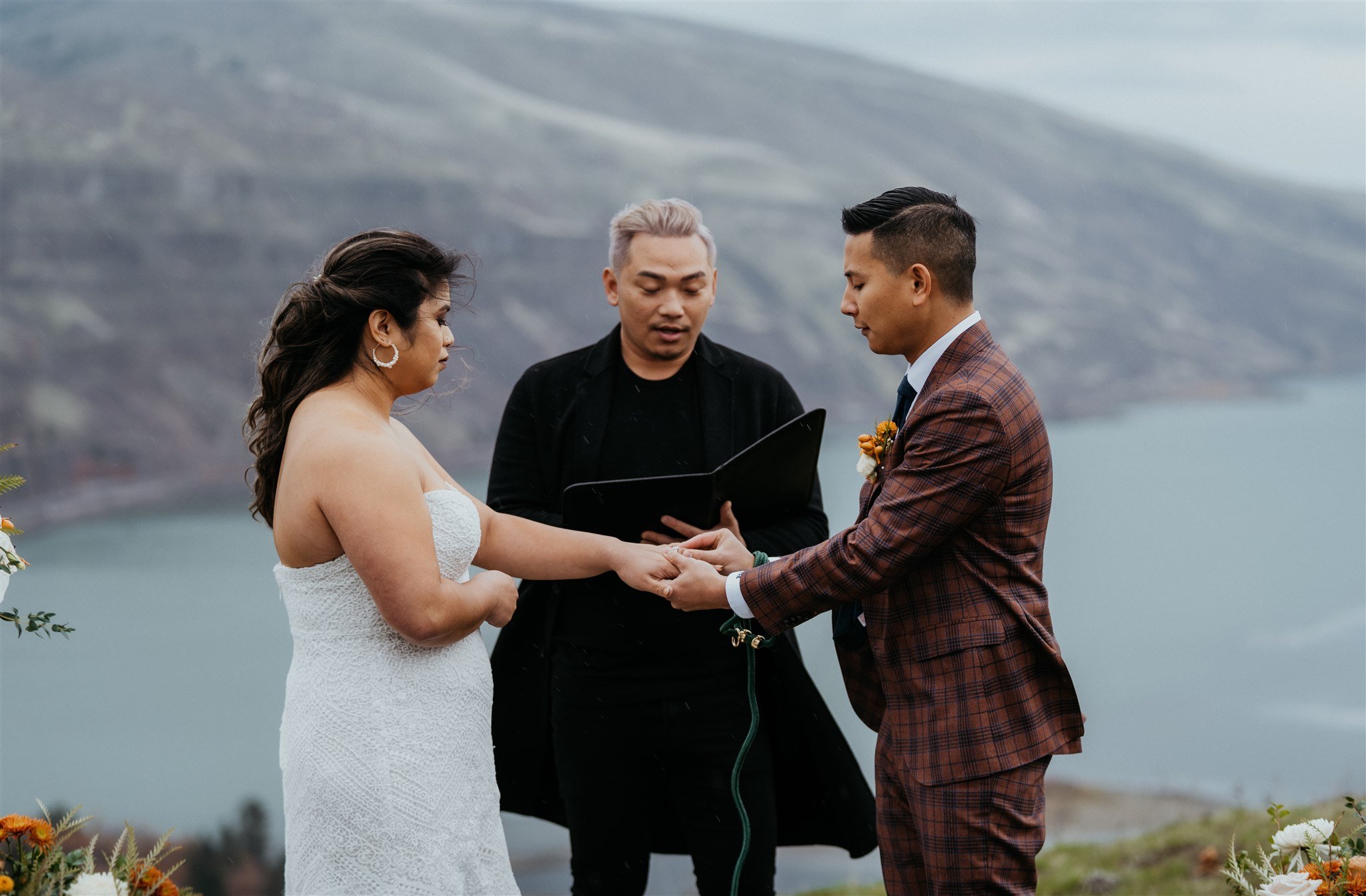 Bride and groom exchange rings at Oregon elopement ceremony