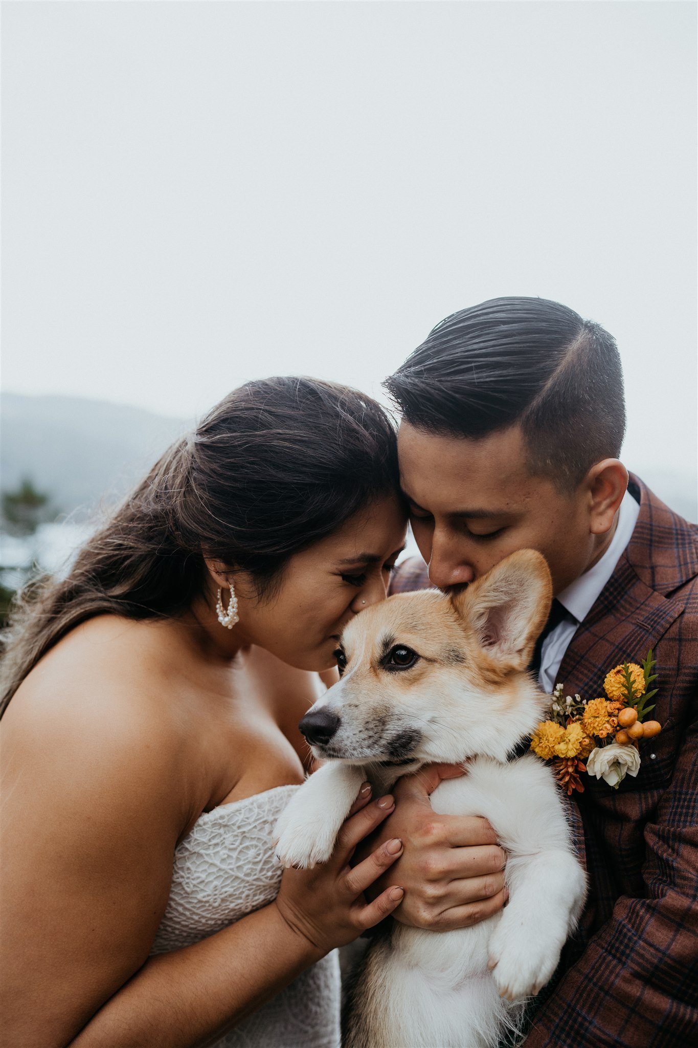 Bride and groom kiss Corgi pup after they elope in Portland
