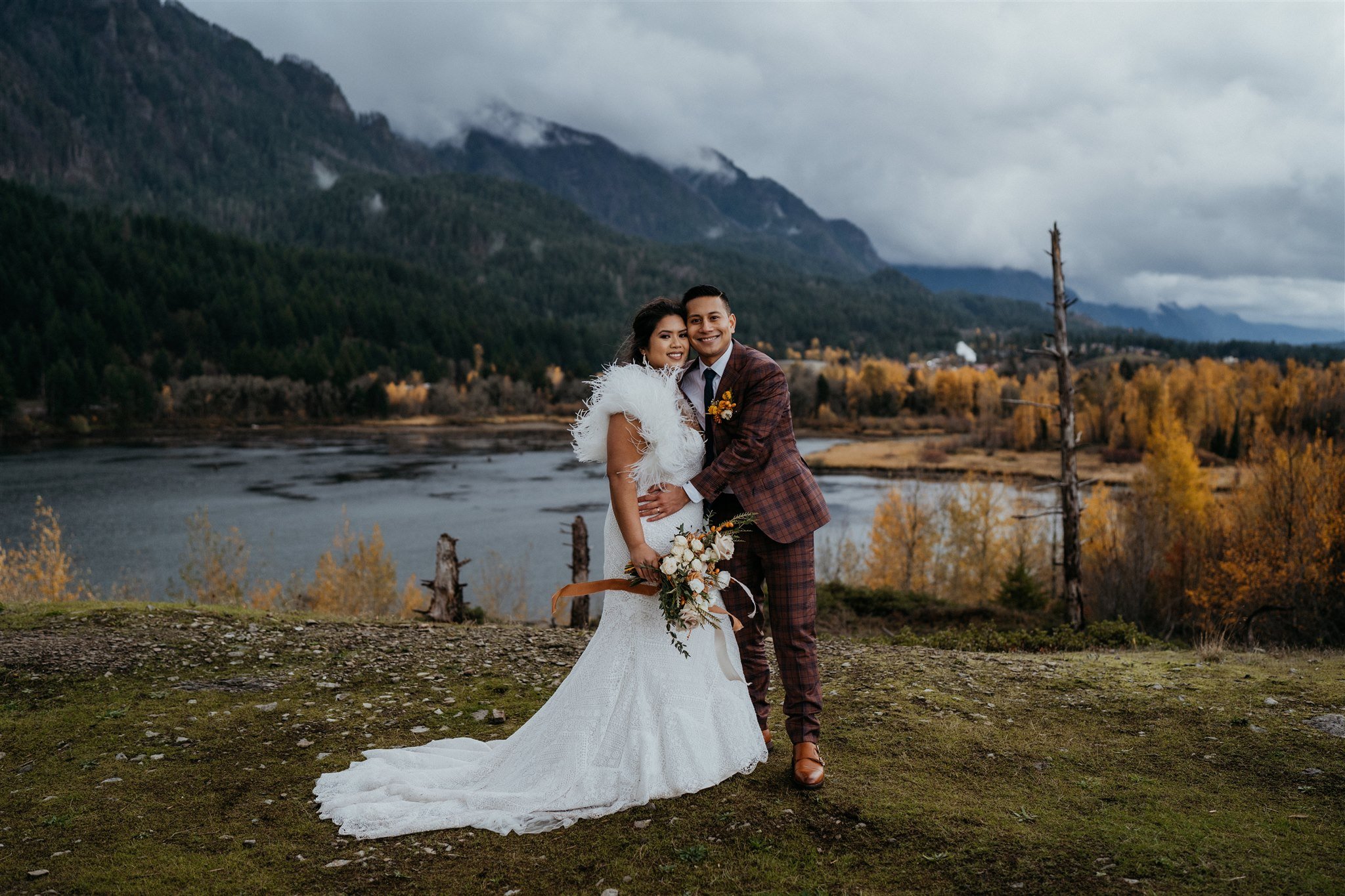 Bride and groom hug during autumn elopement photos in Portland