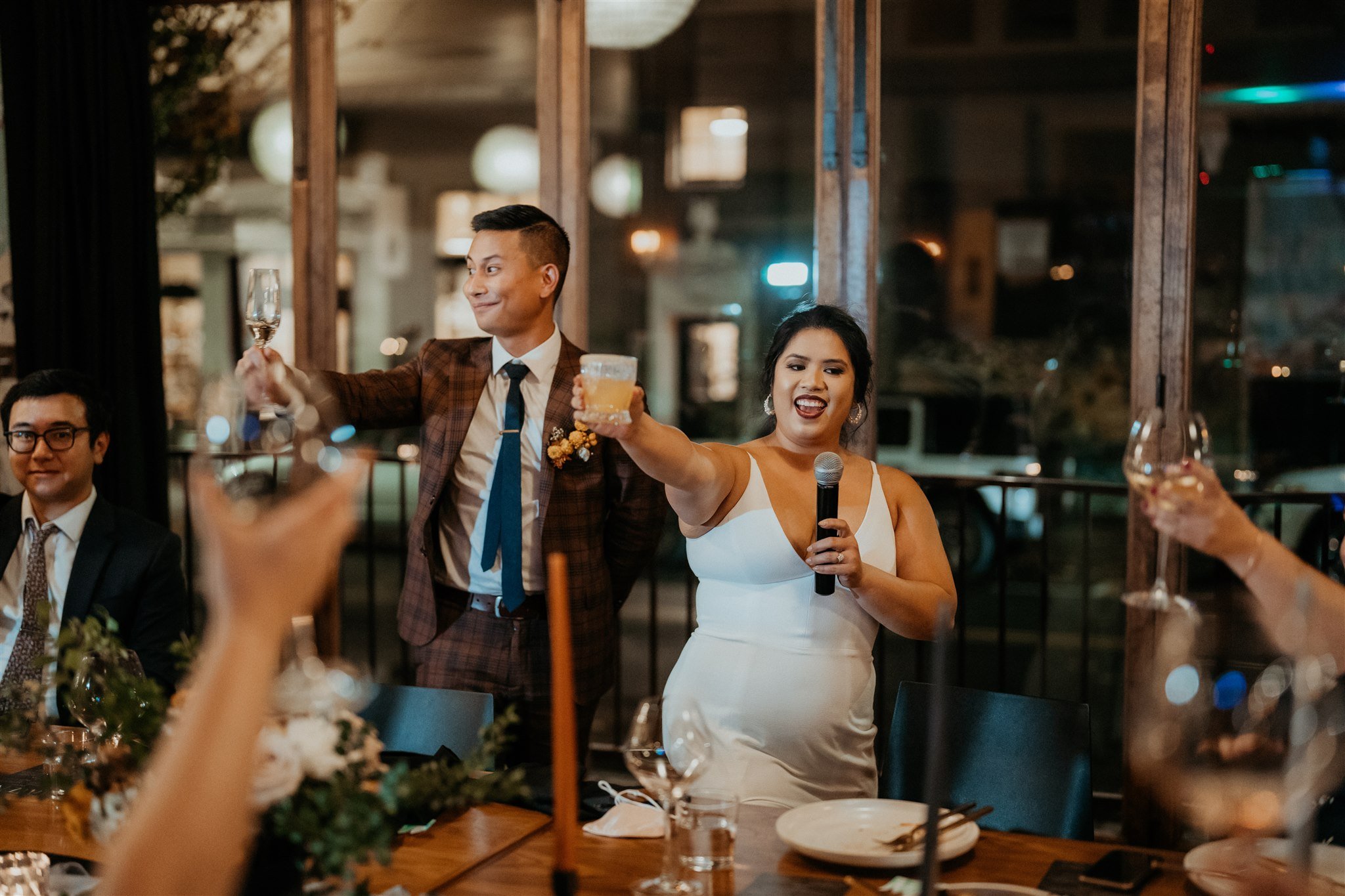 Bride and groom toast with guests at Portland wedding reception