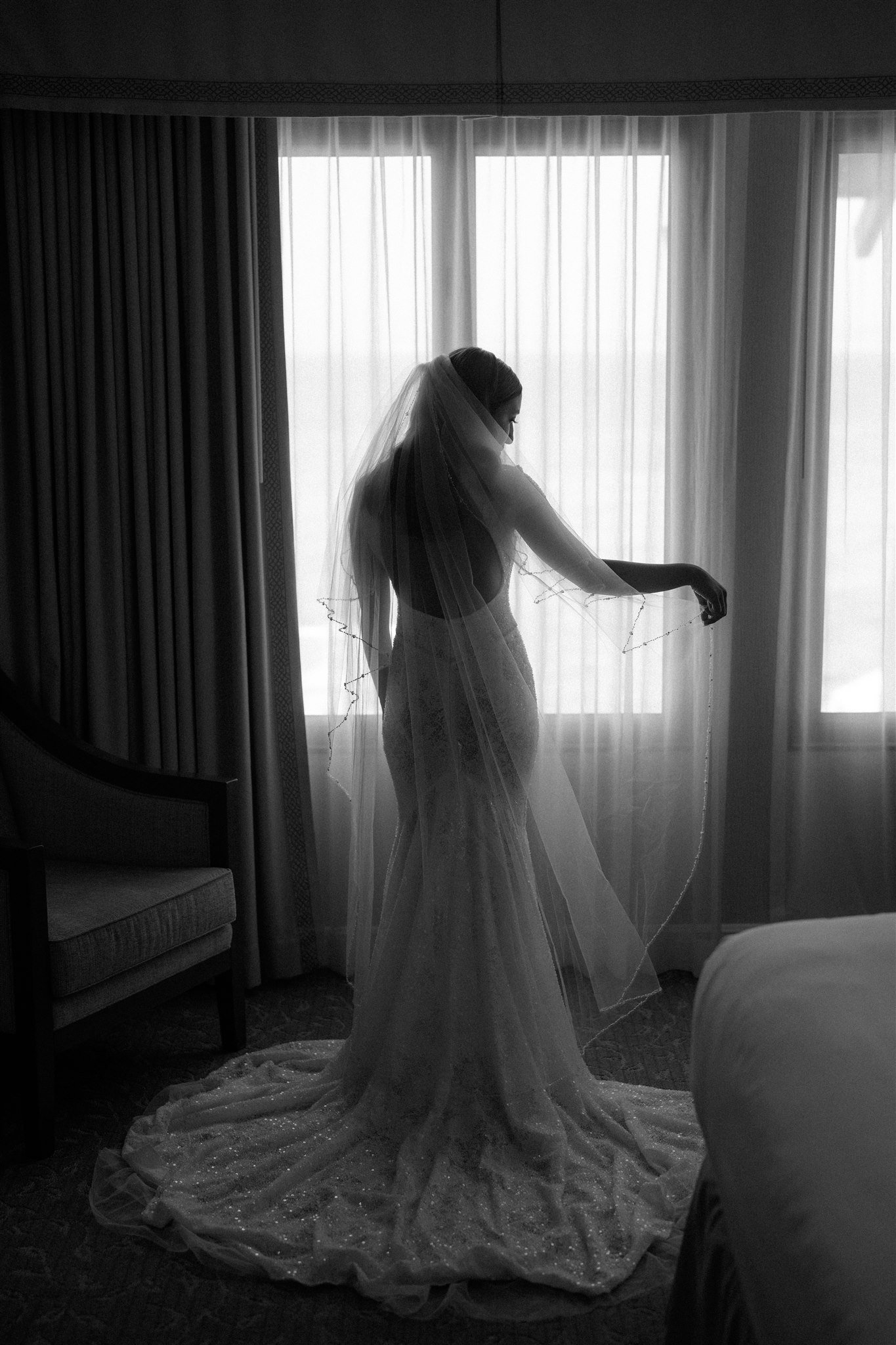 Bride playing with veil while getting ready for Big Sur Elopement
