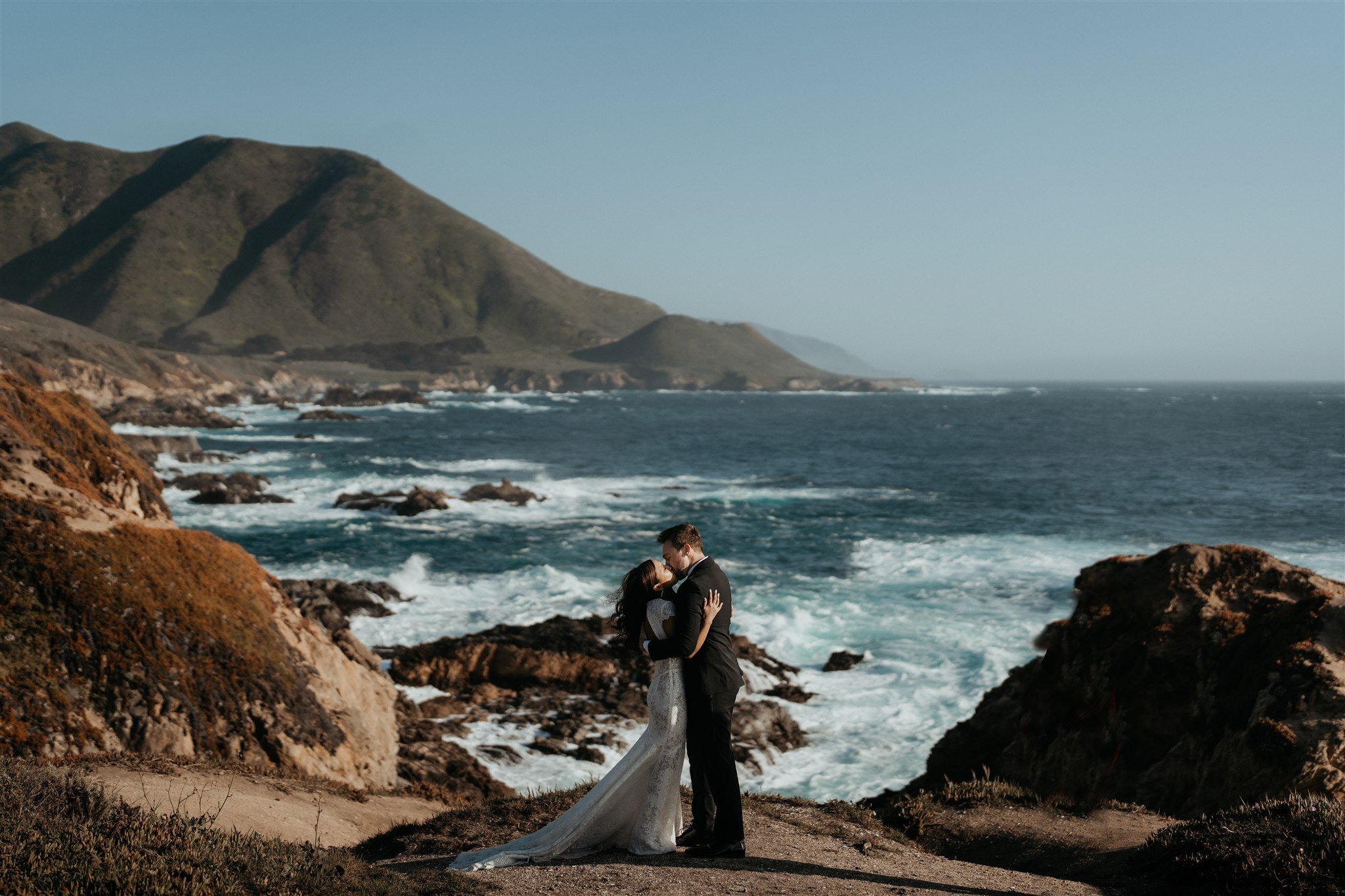 Bride and groom kiss at a Big Sur elopement location overlooking the ocean
