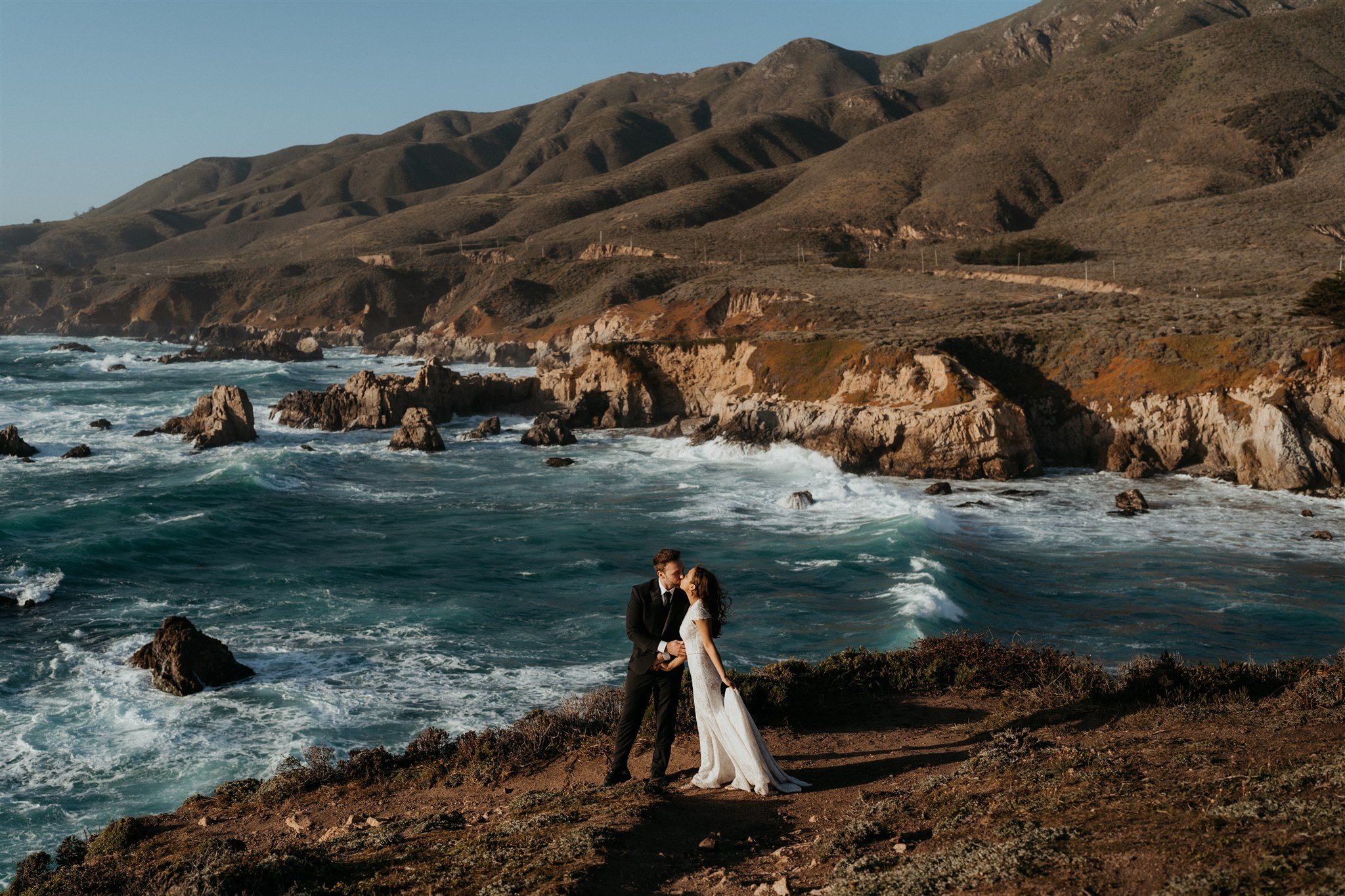 Bride and groom kiss at a Big Sur elopement location overlooking the ocean