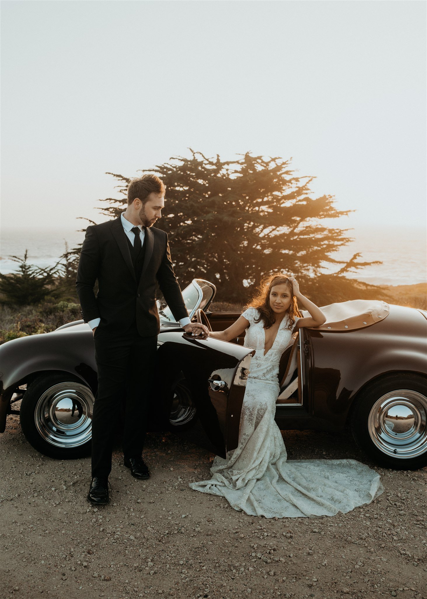 Bride and groom couple portraits with a vintage convertible car in Big Sur
