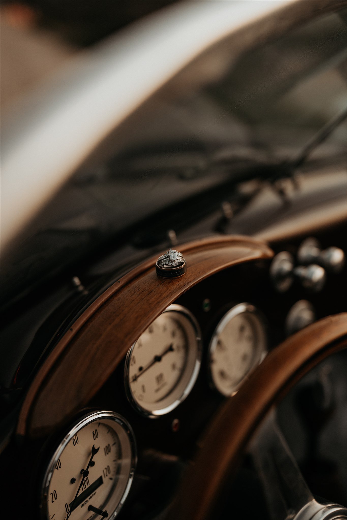 Couples rings sitting on the dashboard of vintage convertible