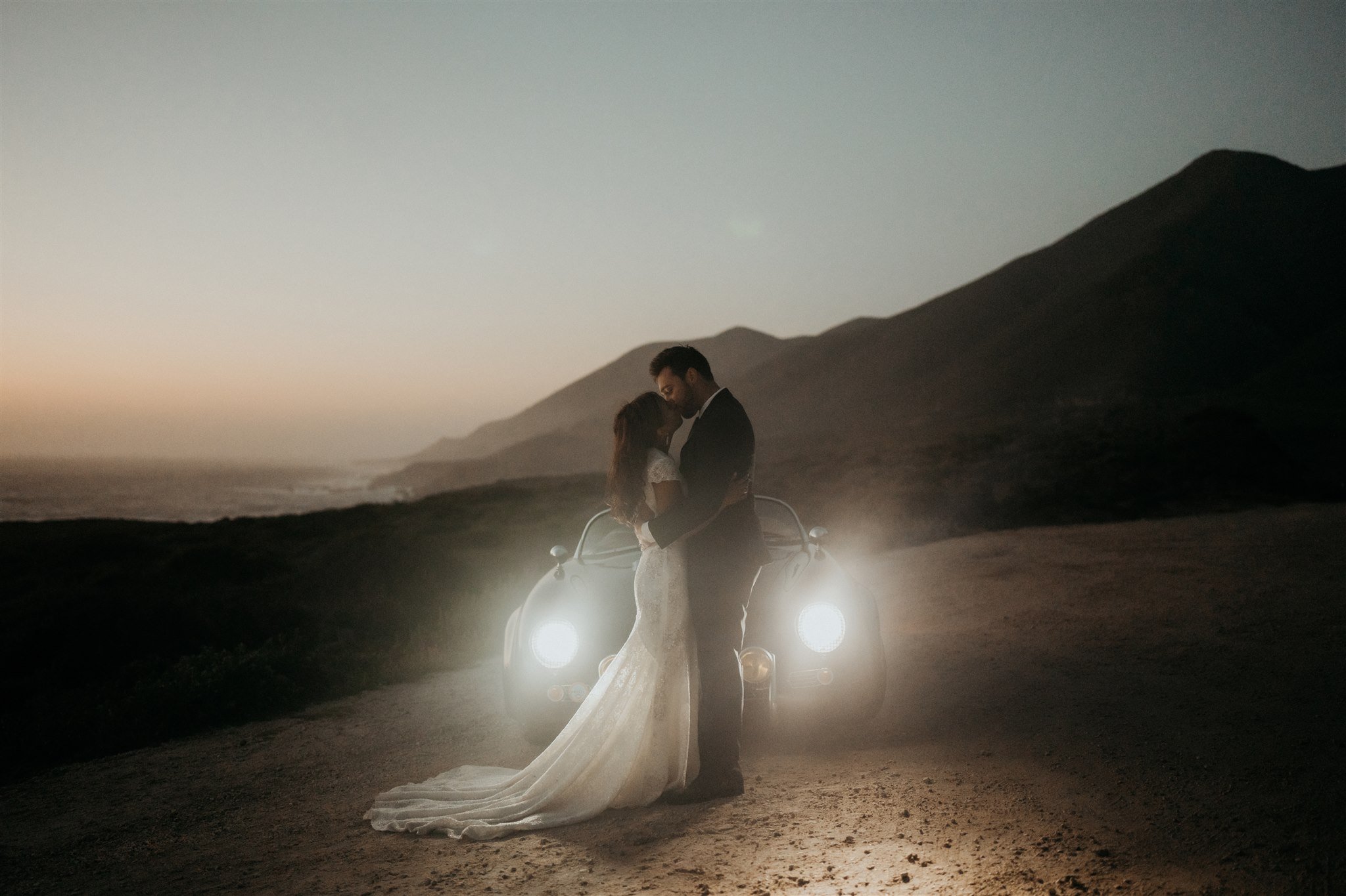 Bride and groom kiss during sunset portraits at Big Sur elopement