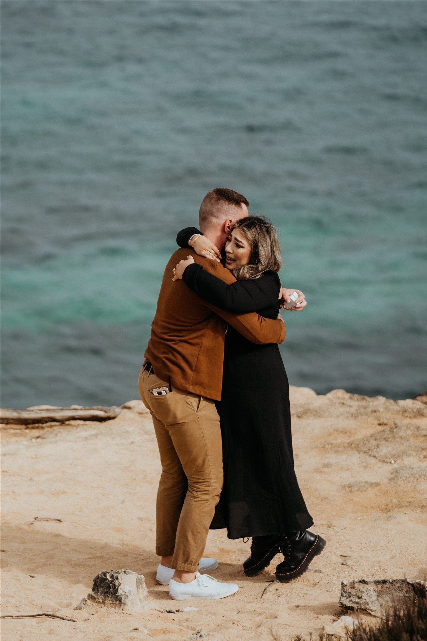 Couple hugging after surprise proposal in Kauai, Hawaii