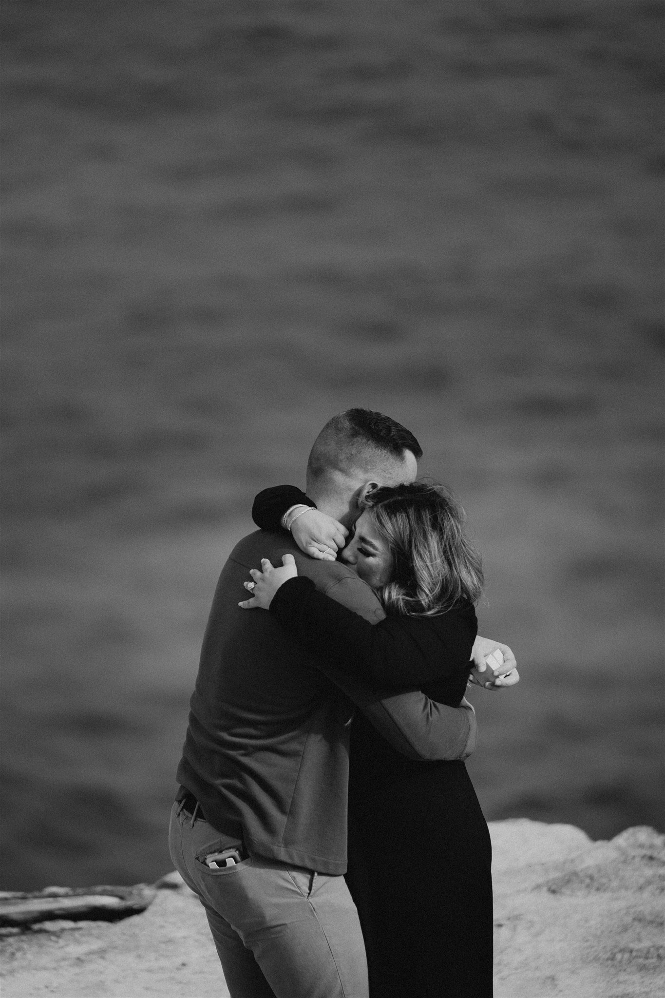 Couple hugging after surprise proposal in Kauai, Hawaii