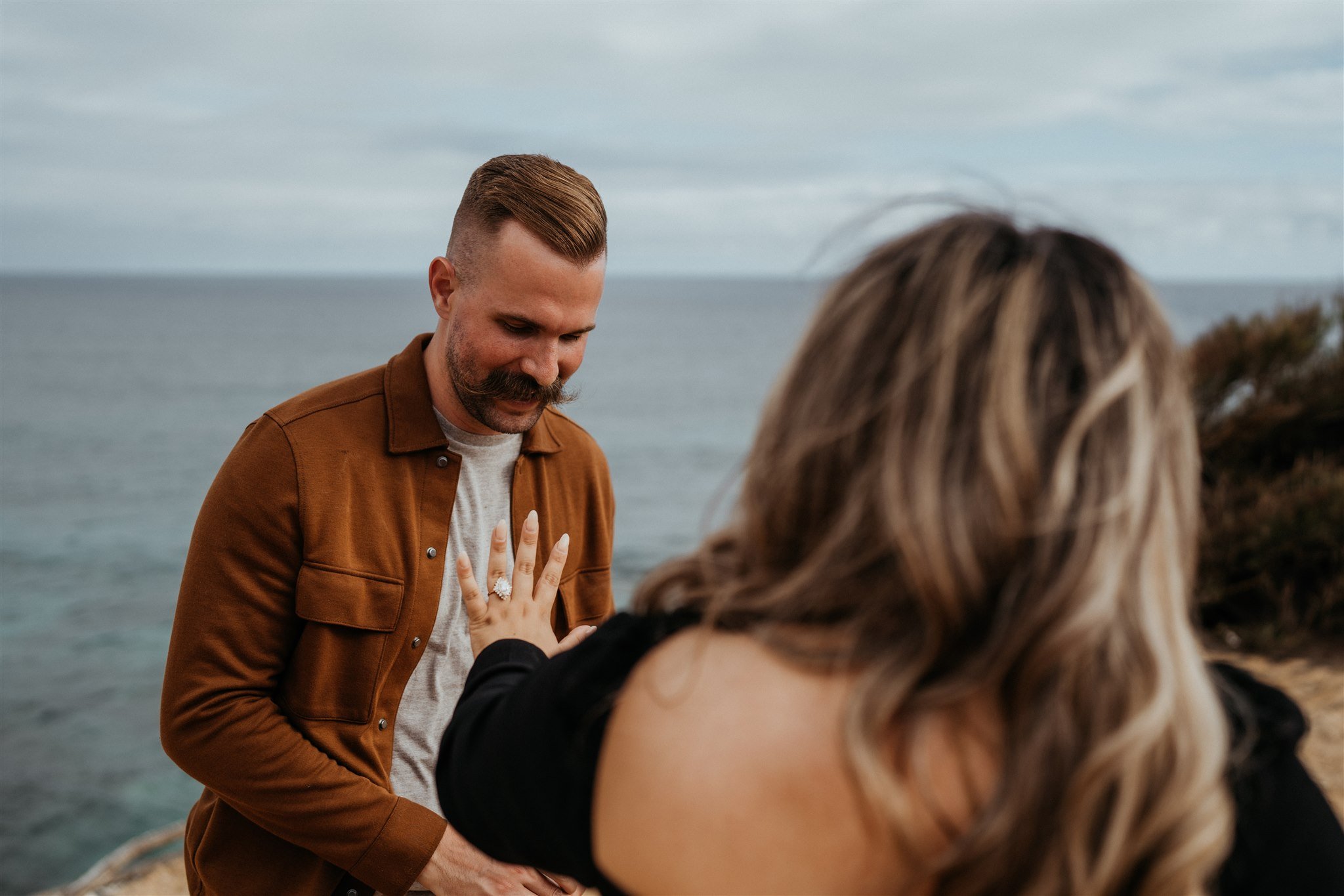 Woman holding out hand after surprise proposal in Kauai, Hawaii