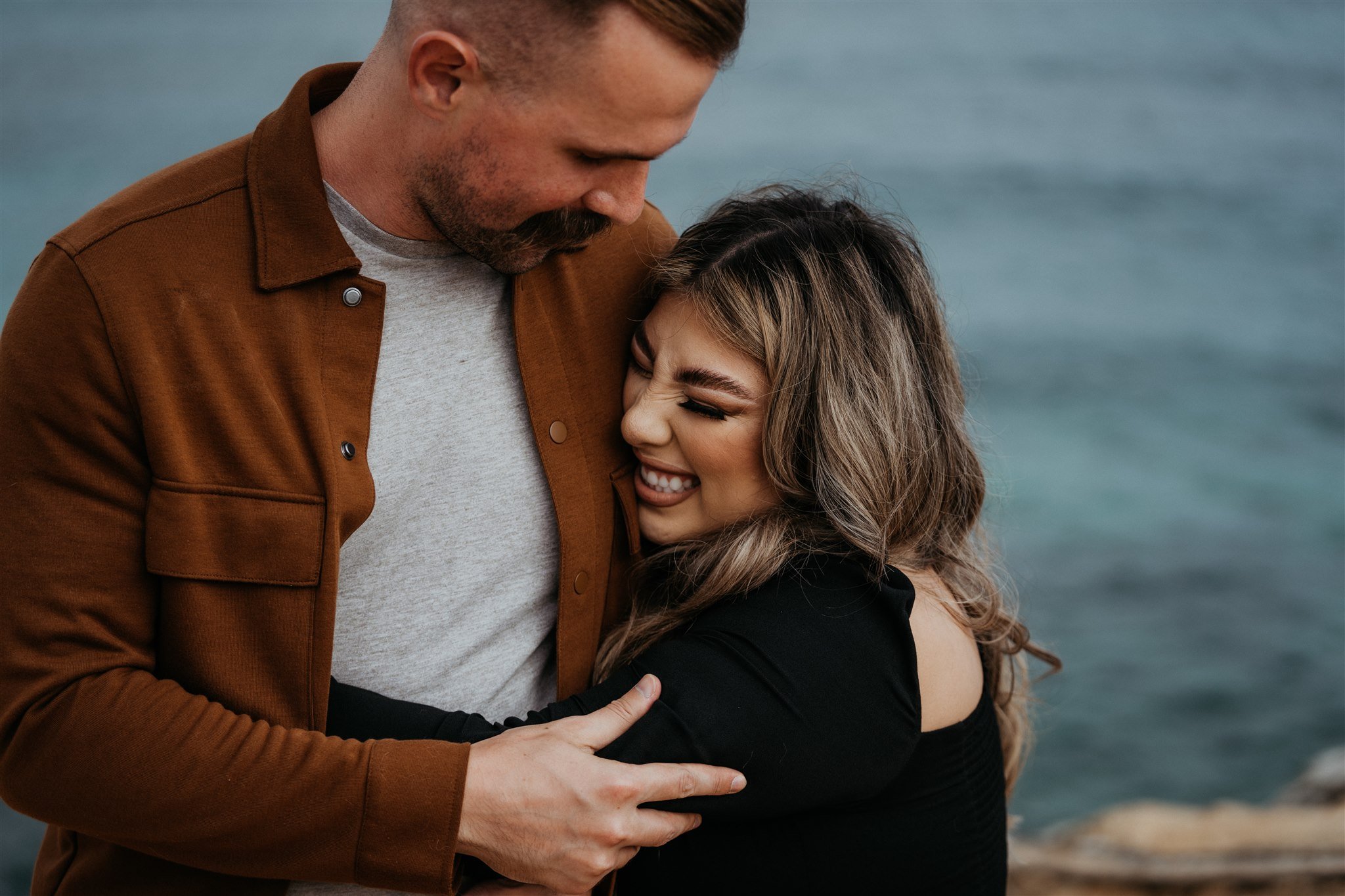 Couple hugging after surprise proposal in Kauai, Hawaii