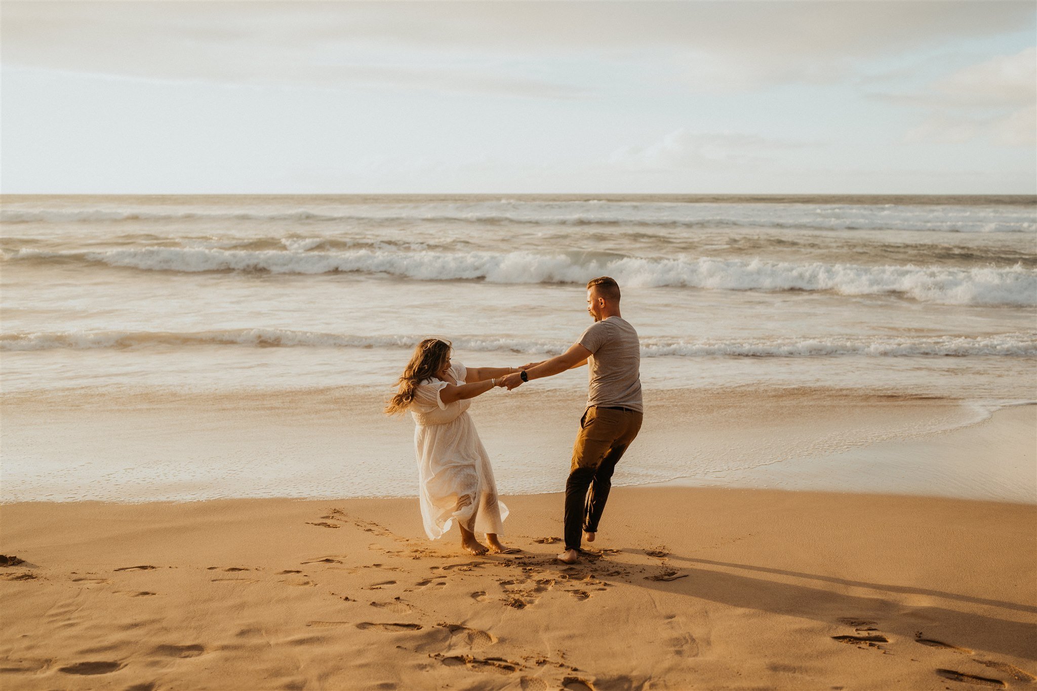 Couple dancing on the beach during Hawaii engagement photos