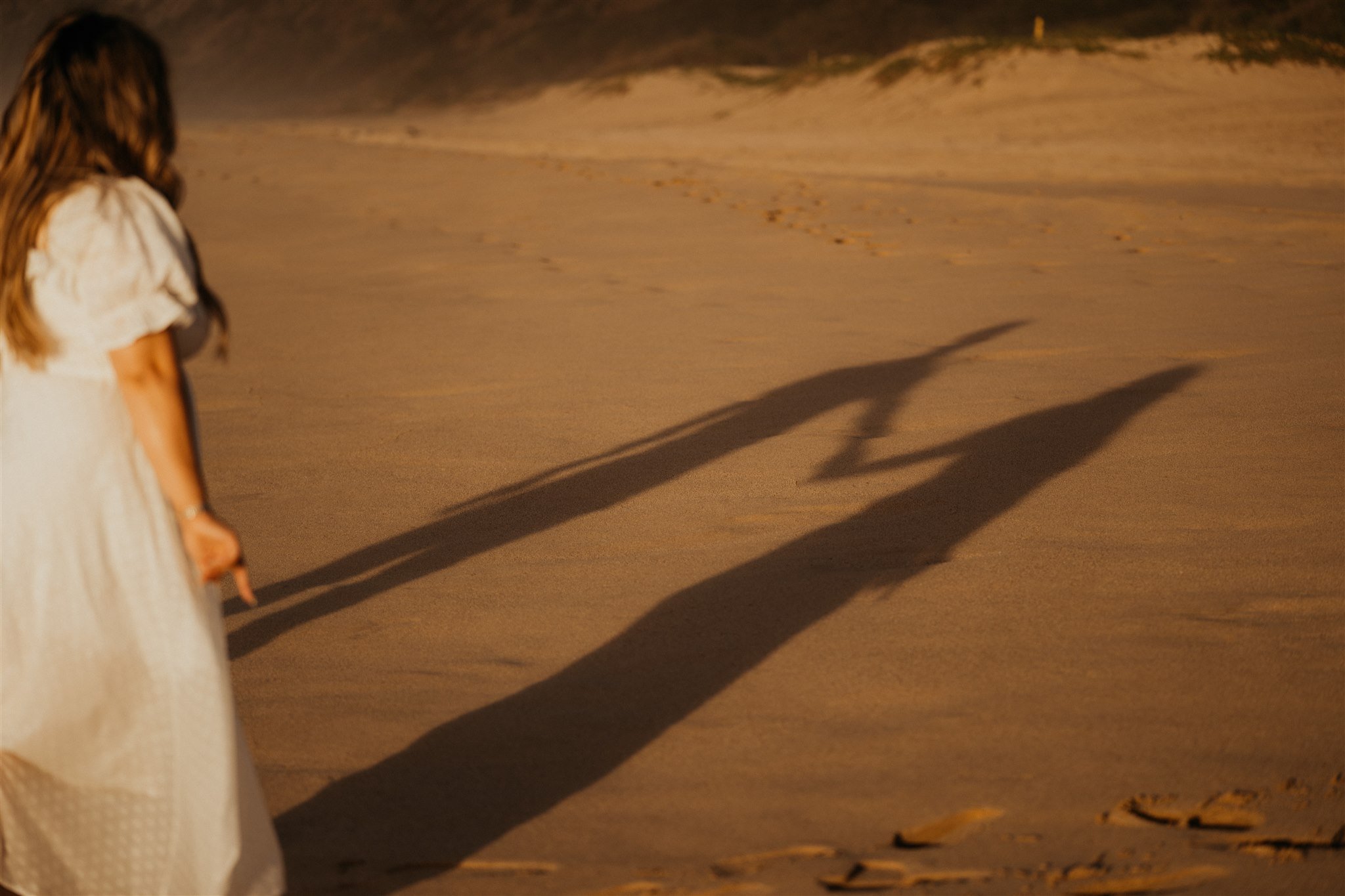 Couple holding hands on the beach during Hawaii engagement photoshoot