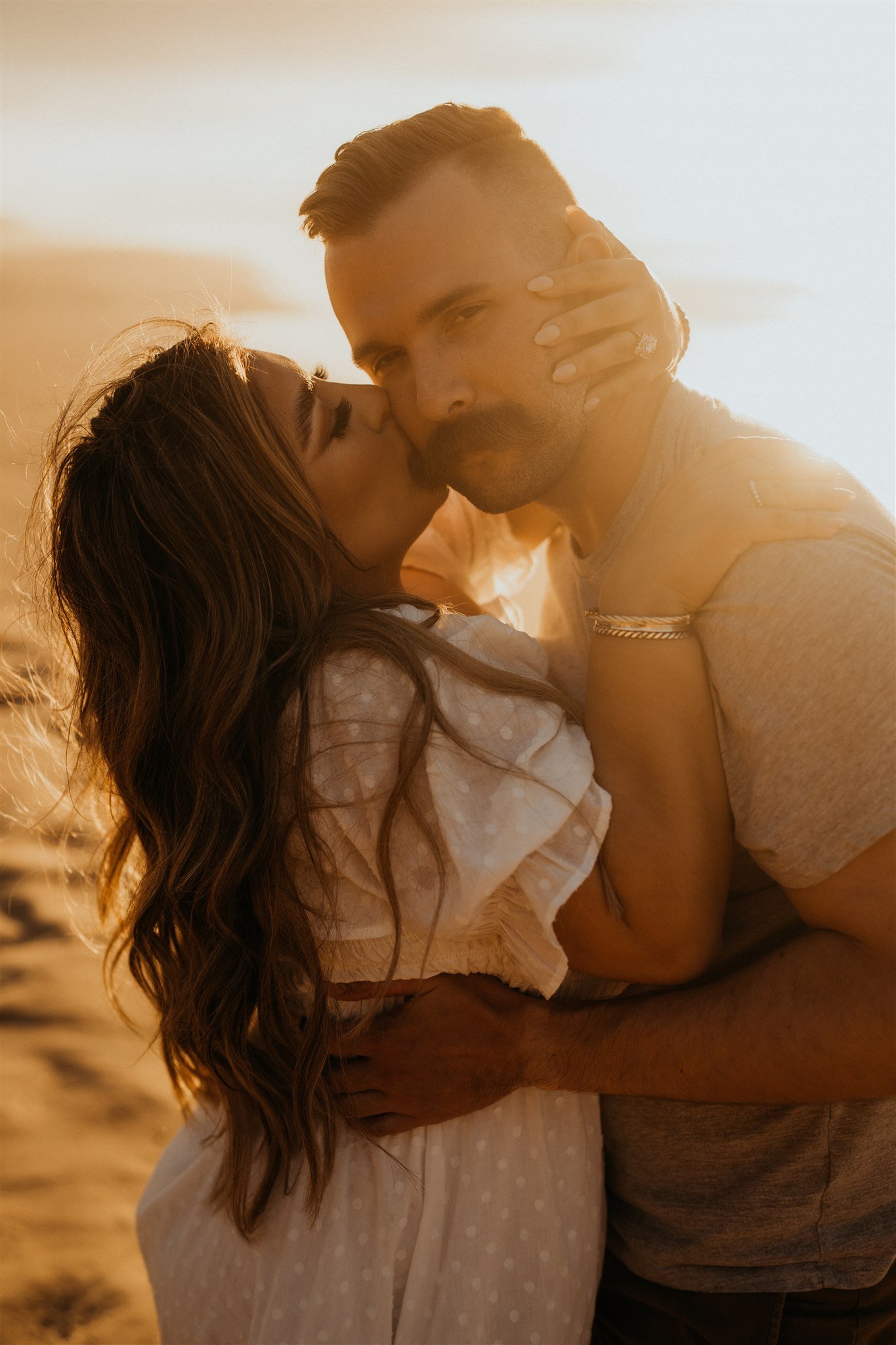 Woman kissing man on the cheek during Hawaii engagement photos